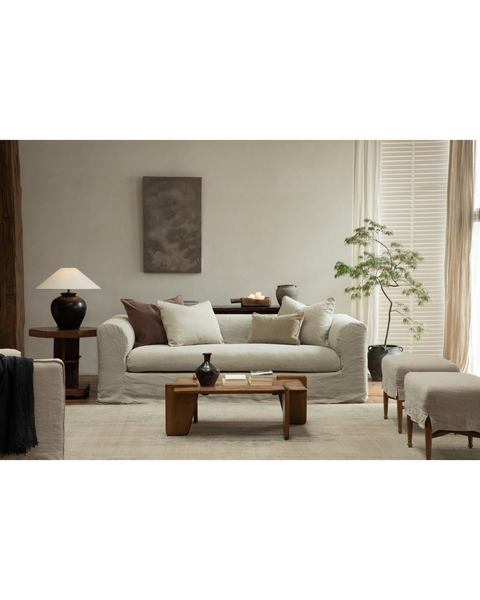 Neutral woven linen Charlotte sofa with removable slipcover, mid-century modern living room.