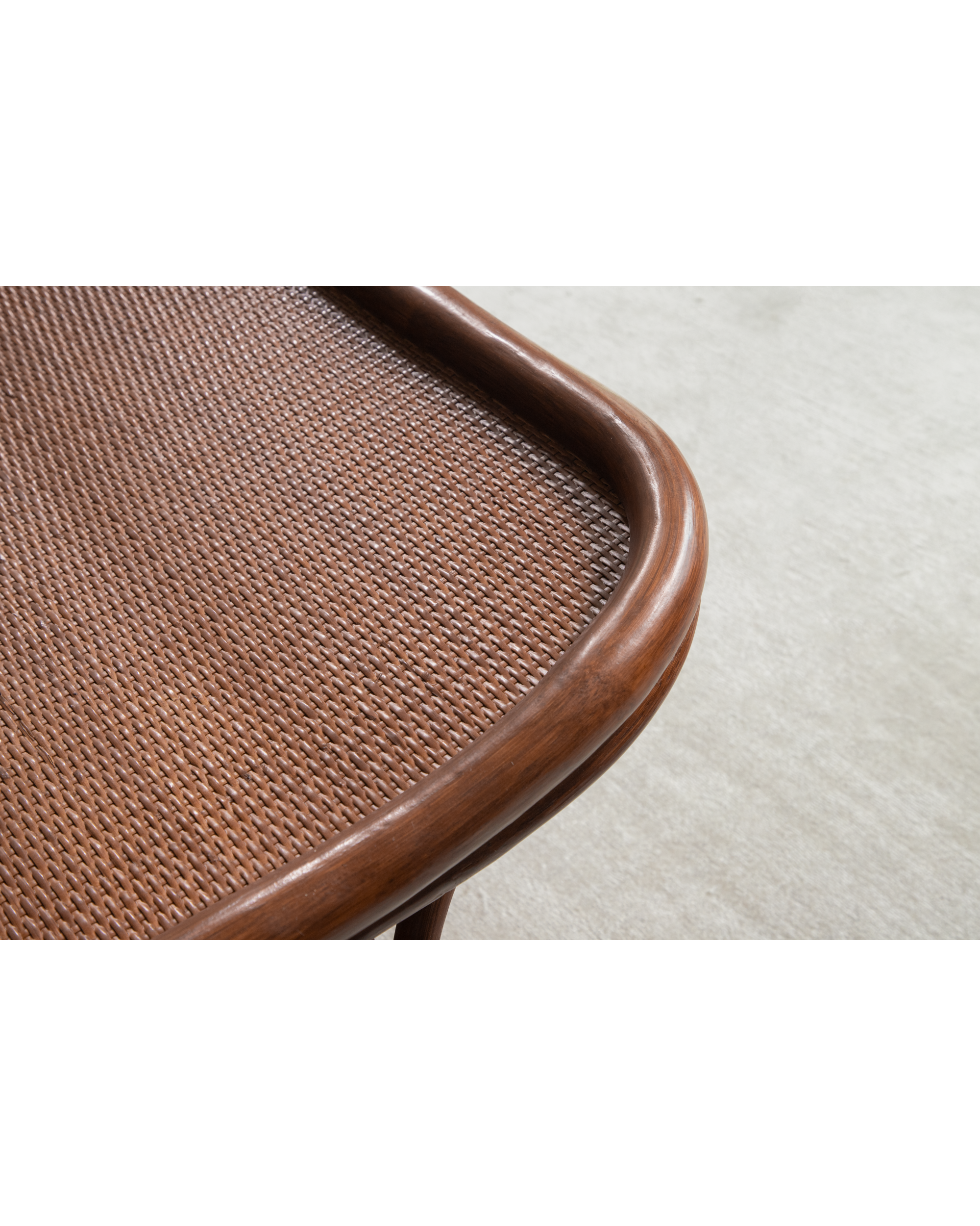Twyla Storage Bench: woven rattan detail with curved wood frame