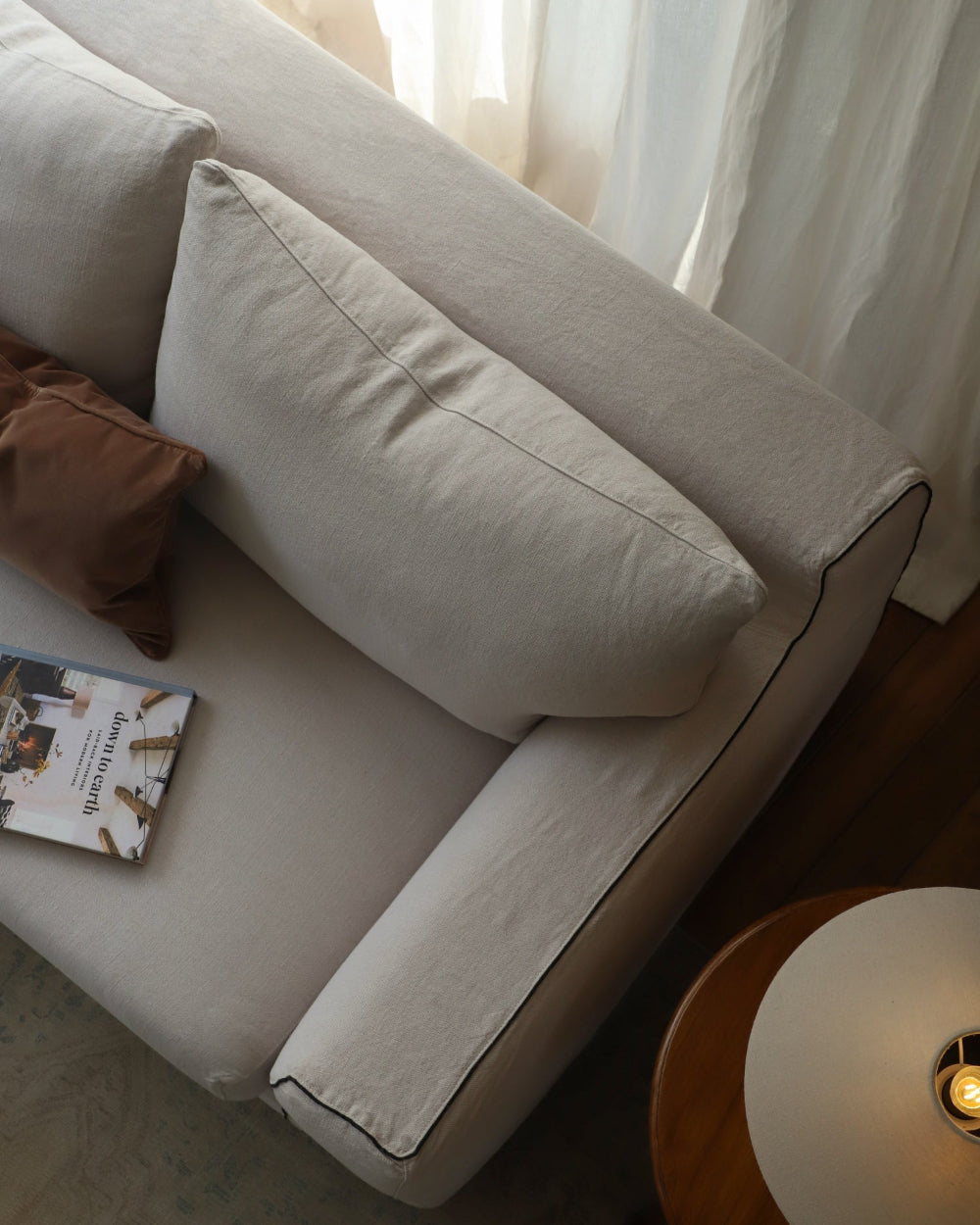 Noa Sectional Sofa in beige linen with plush cushions and black piping, modular design.