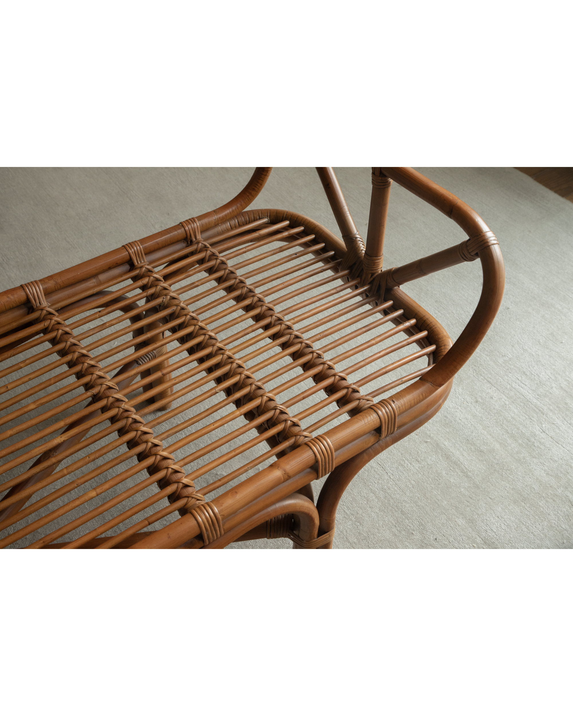 Bridget Bench: Intricate woven rattan seat and natural cane frame details.