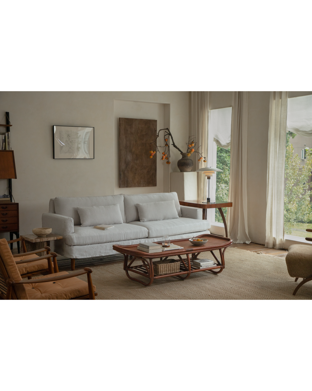 Twyla Storage Bench in rattan, shown as a versatile coffee table in a living room scene.