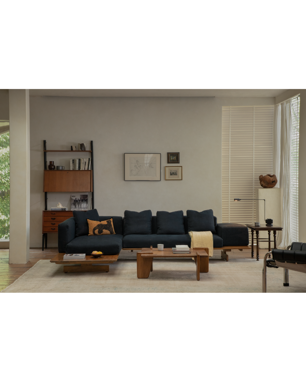 Deep navy Tatami Linen Modular Sofa with linen upholstery and wooden coffee table.