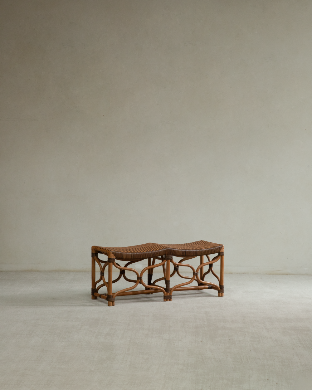 Melange rattan bench with curved woven seat and openwork legs