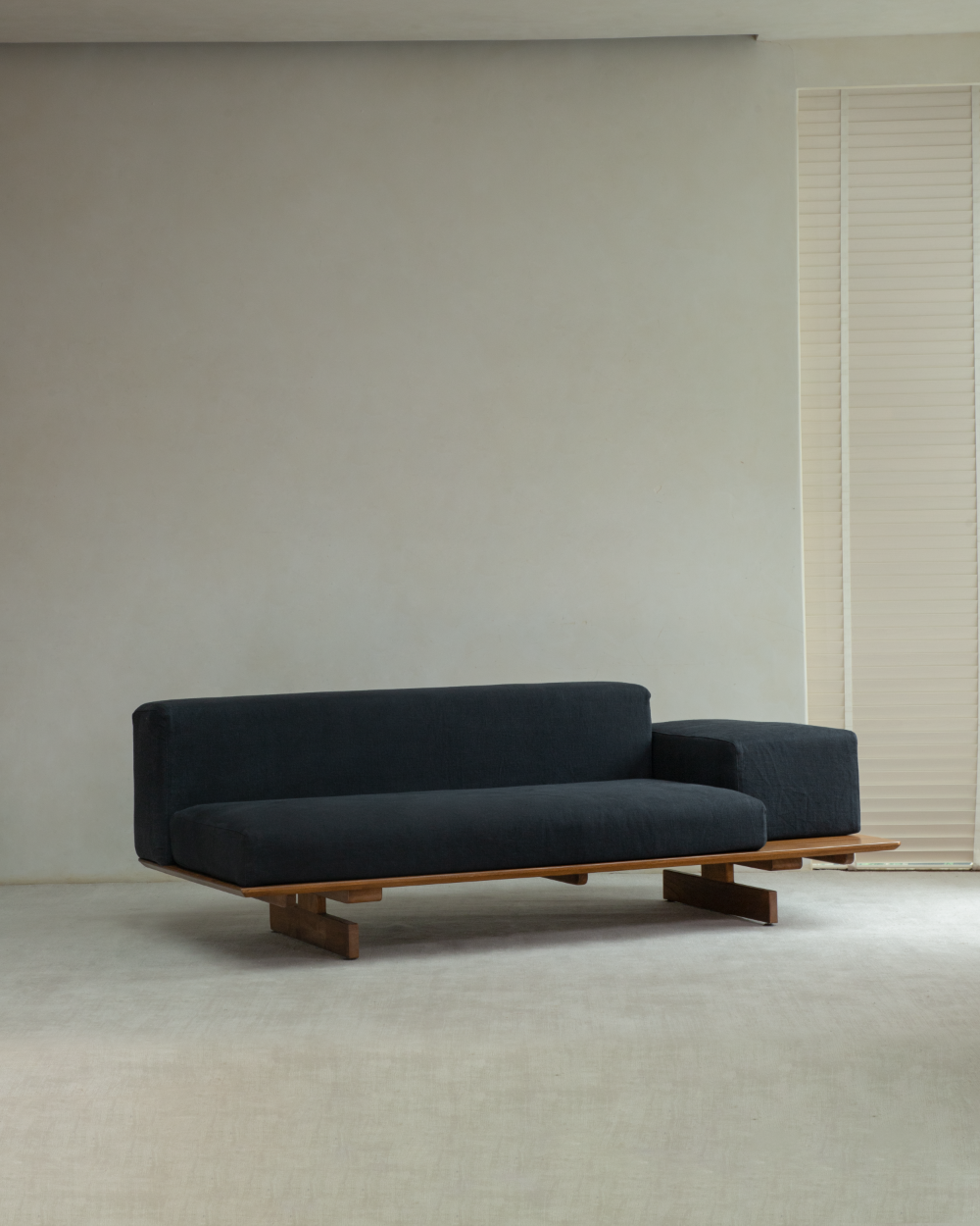 Black Tatami Linen modular sofa with teak wood frame.