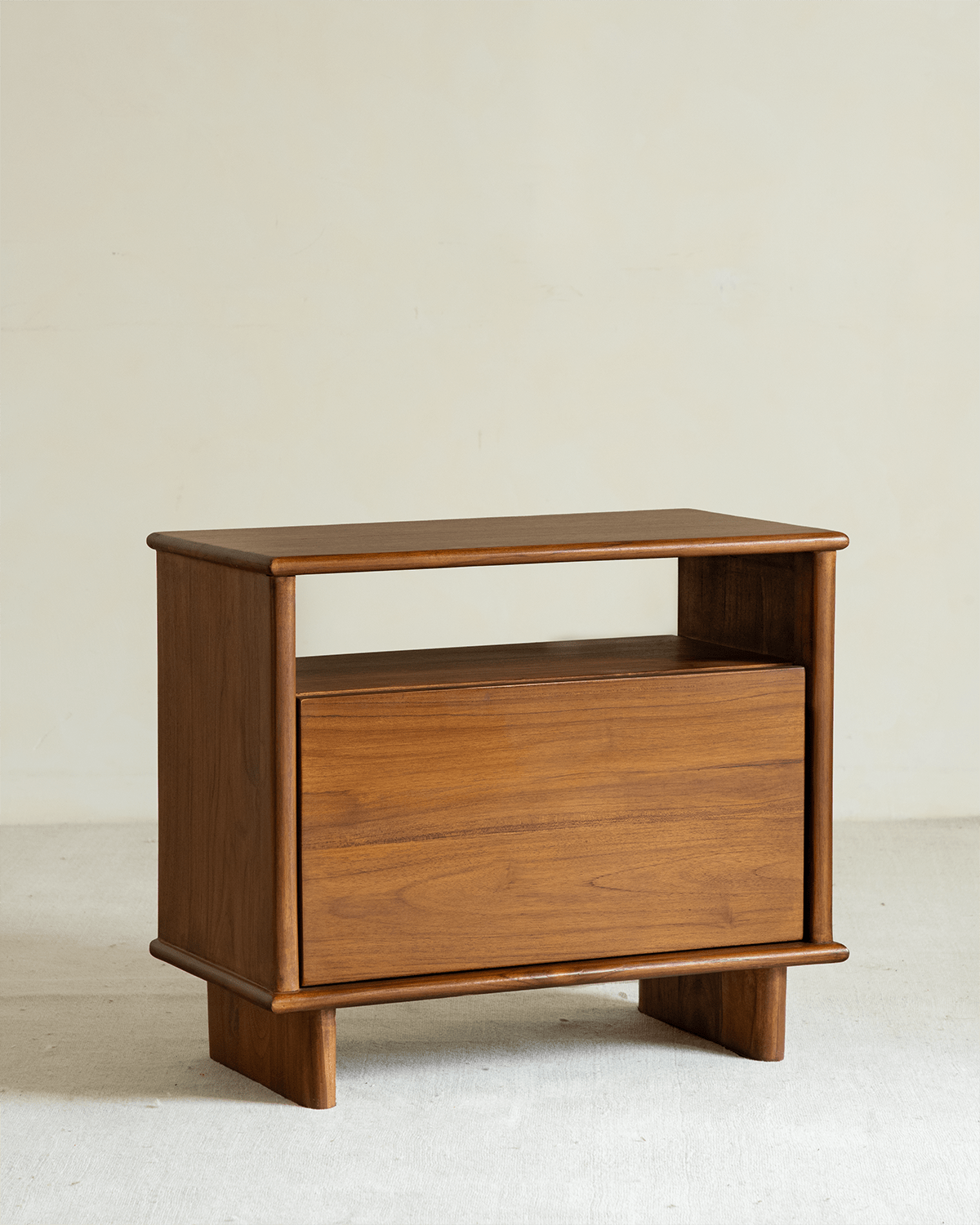 Eleanor solid teak nightstand with open shelf and drawer.