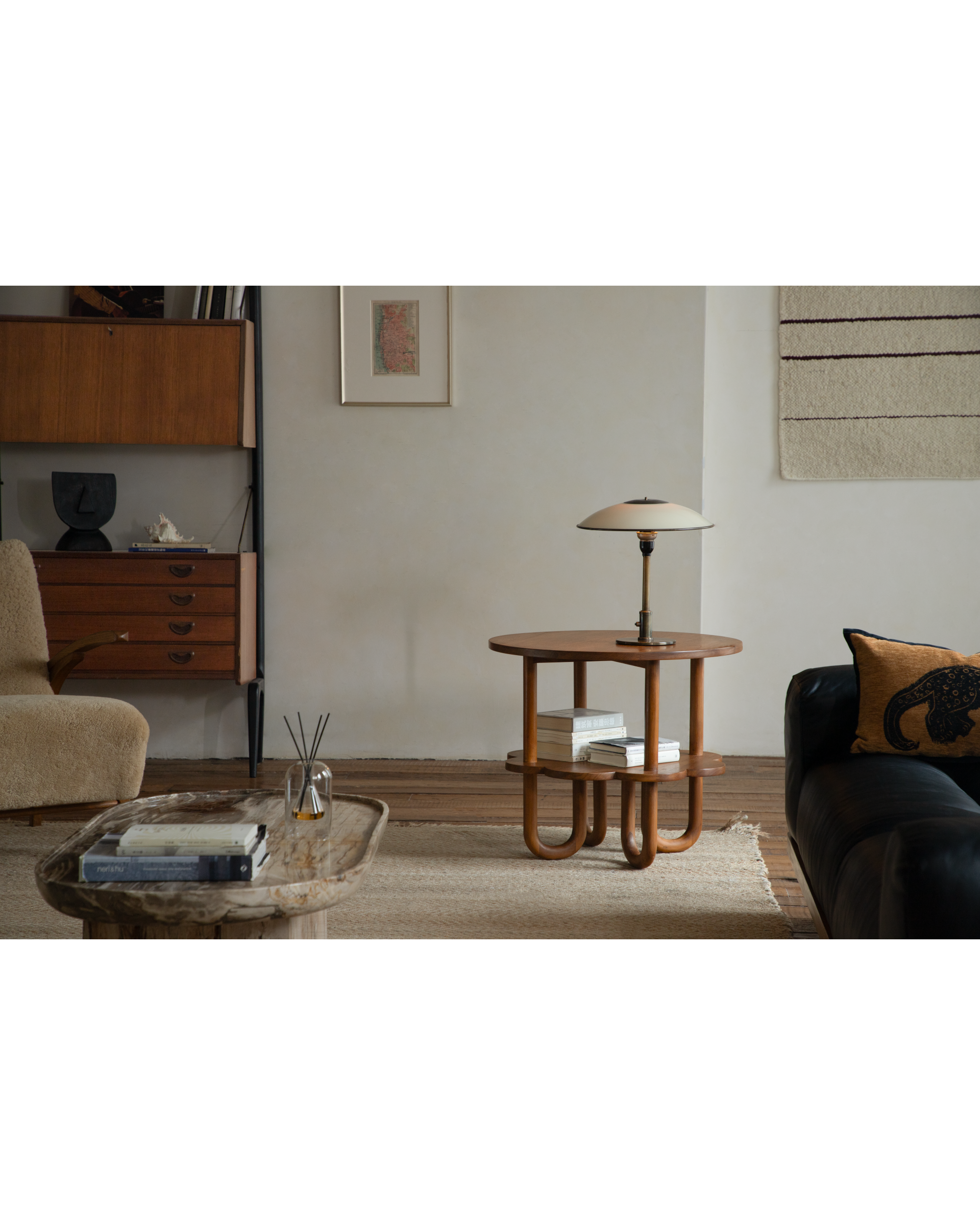 Elegant teak wood Daisy Side Table with curved legs, round top, and staggered shelves.