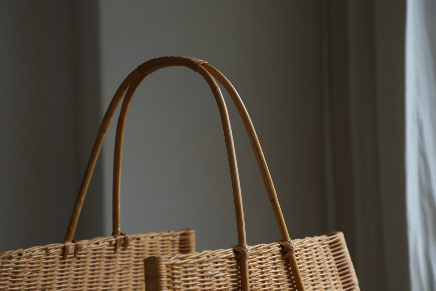 June Basket: Hand-woven natural rattan with sturdy curved handles.