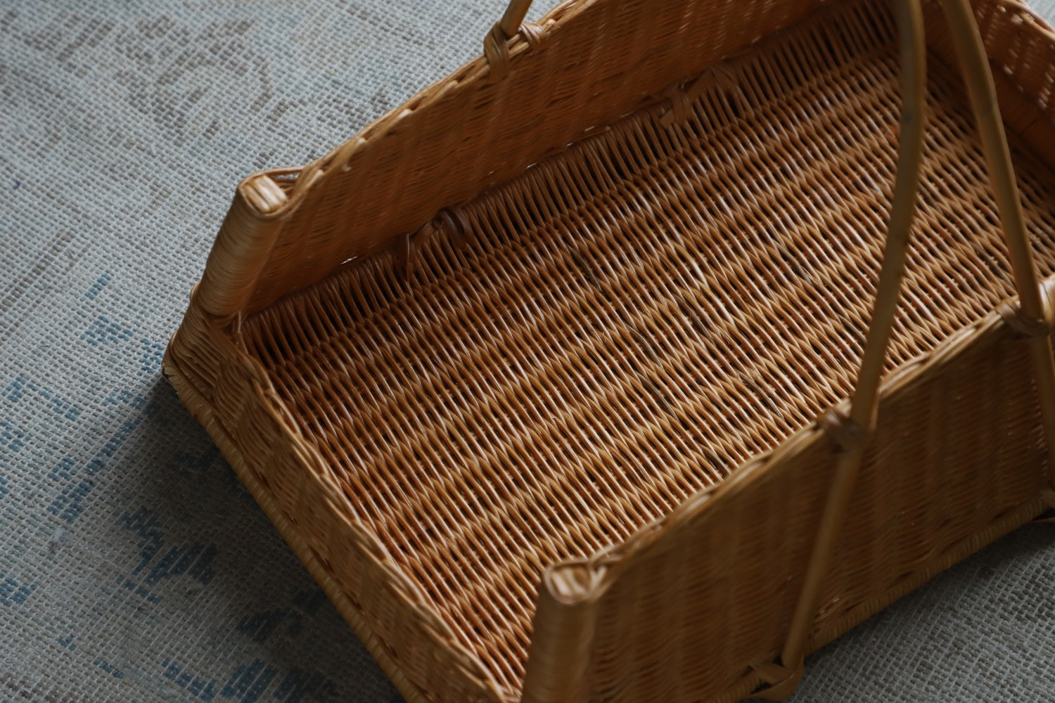 June Basket, natural rattan, hand-woven storage basket with sturdy handles.