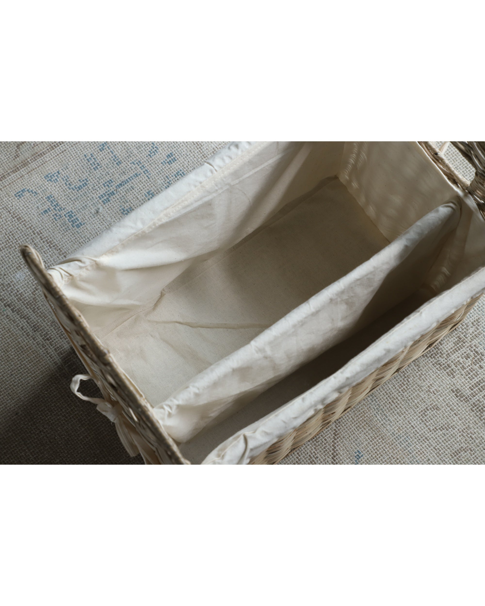 Elara storage basket interior: natural rattan weave with beige cotton lining.