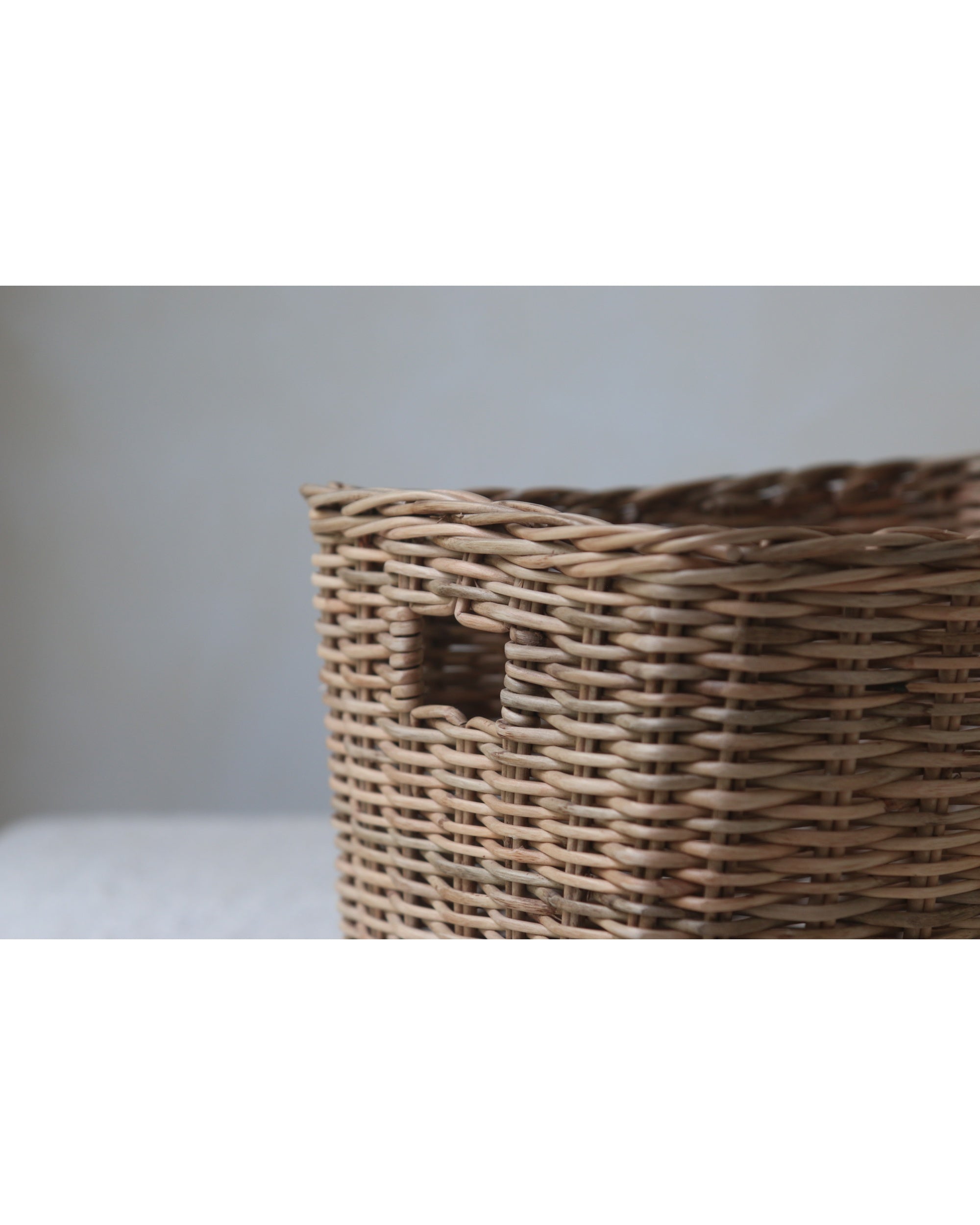 Hand-woven natural fiber storage basket with thick weave and rectangular shape