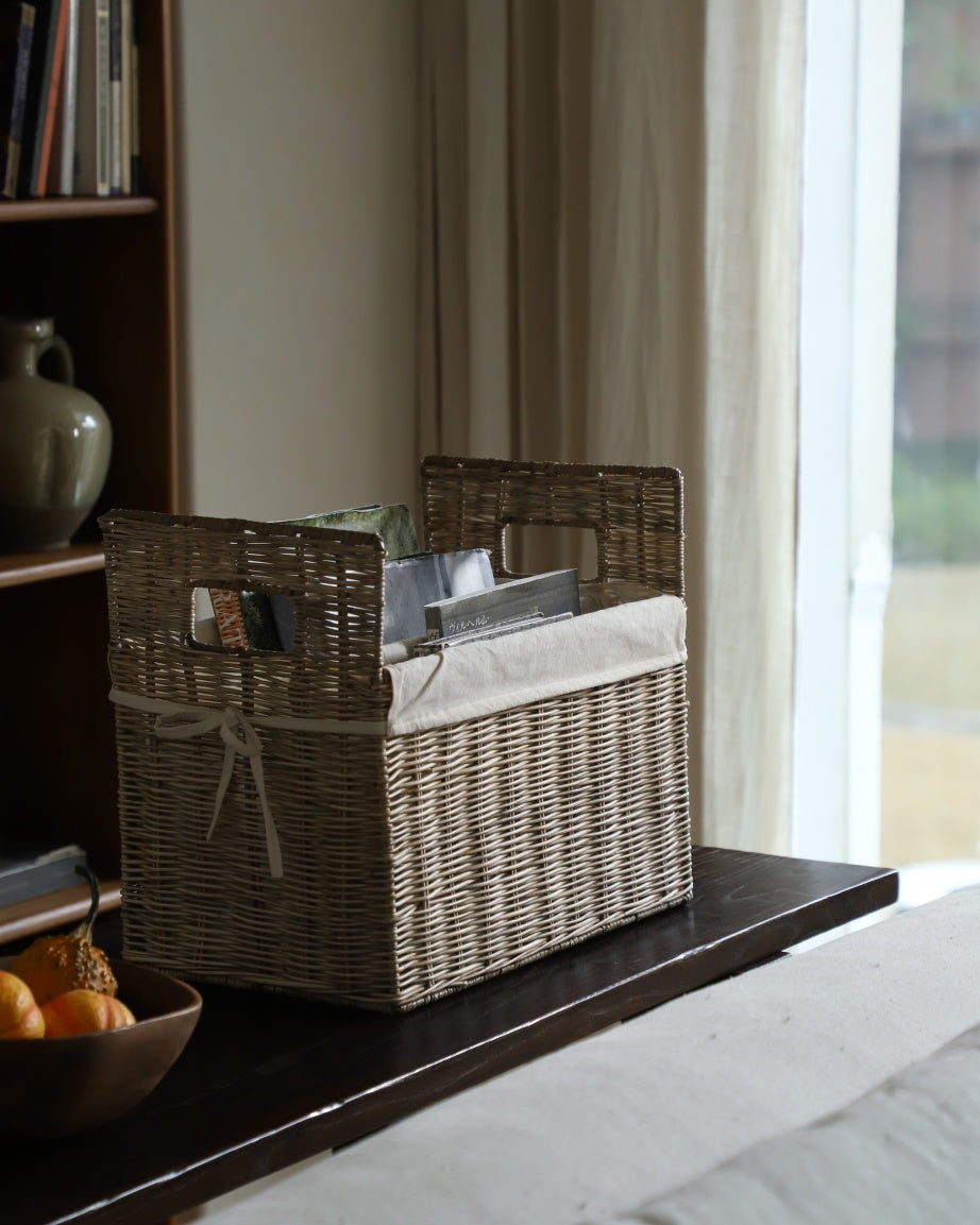 Elara storage basket: natural woven rattan with cotton lining and handles.
