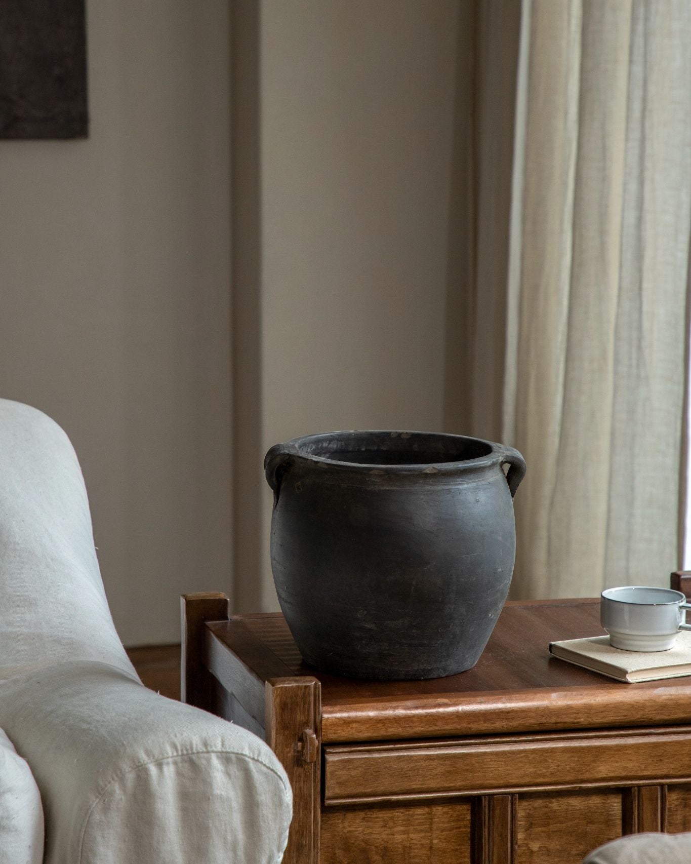 Large clay pot on a wooden table, home decor accent with neutral colors