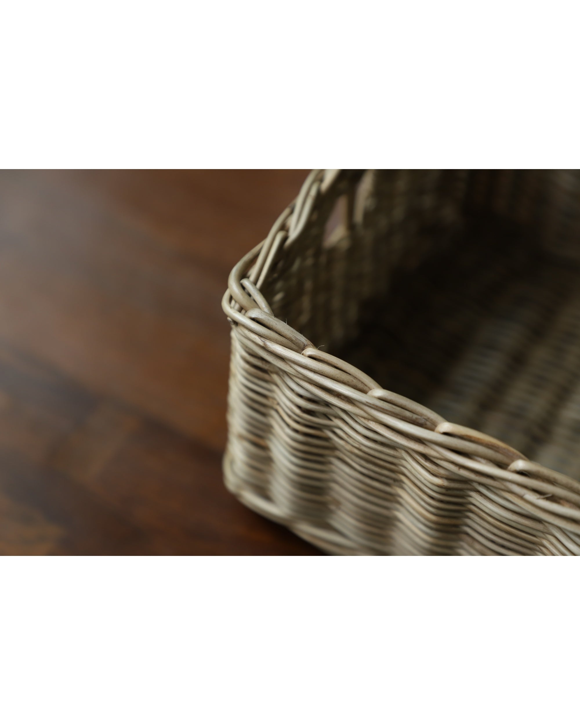 Etta Storage Basket, hand-woven from natural rattan with intricate weave pattern.