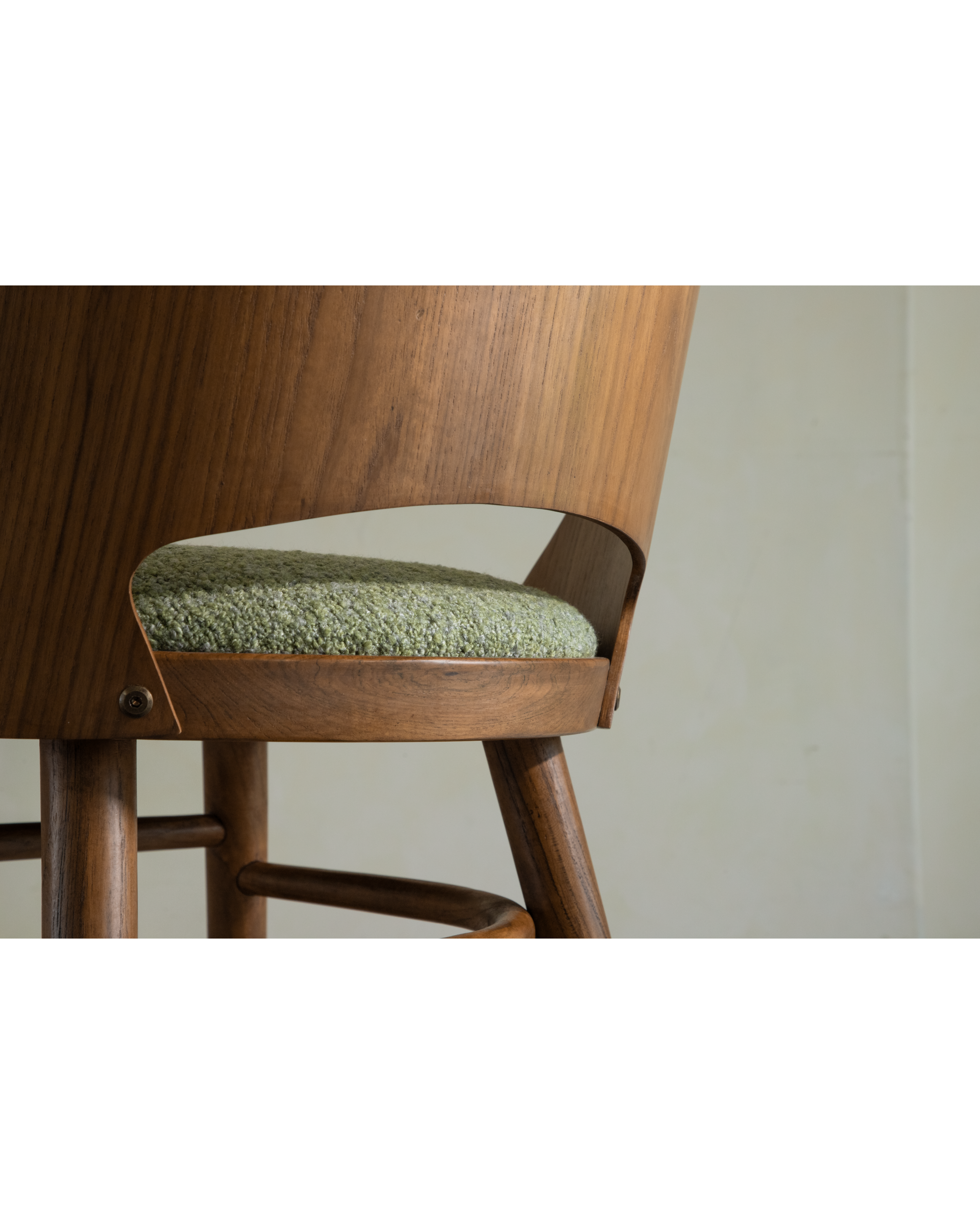 Shell Chair: curved teak wood frame, textured green loop fabric seat cushion.