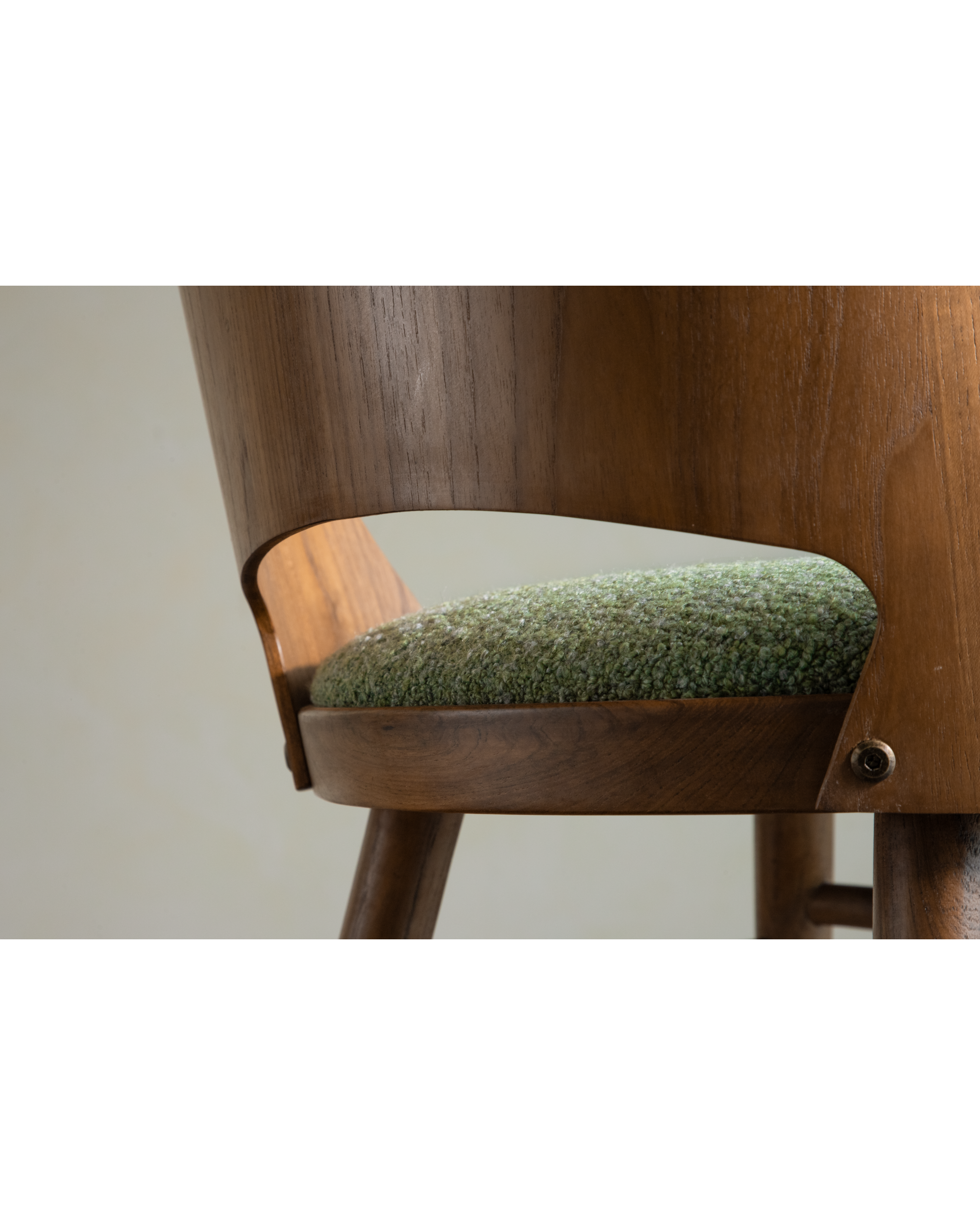 Shell Chair: Curved teak wood frame with textured green loop fabric seat.