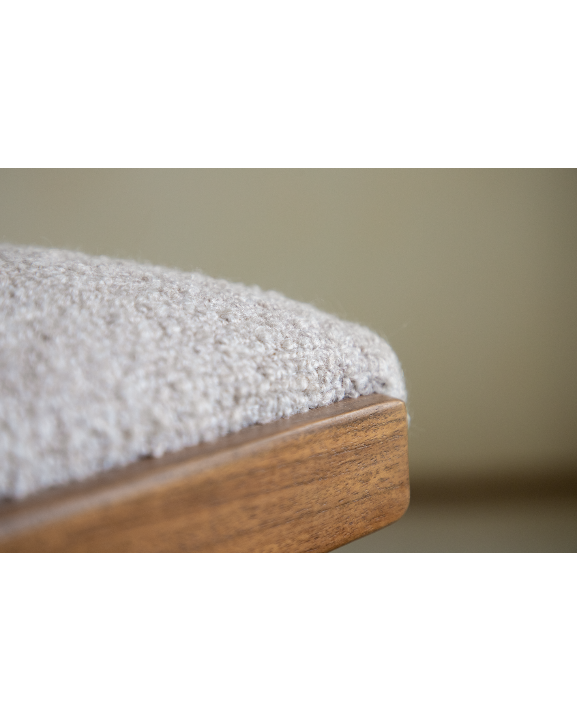 Shell Chair: textured light loop fabric upholstery meets solid teak wood edge.