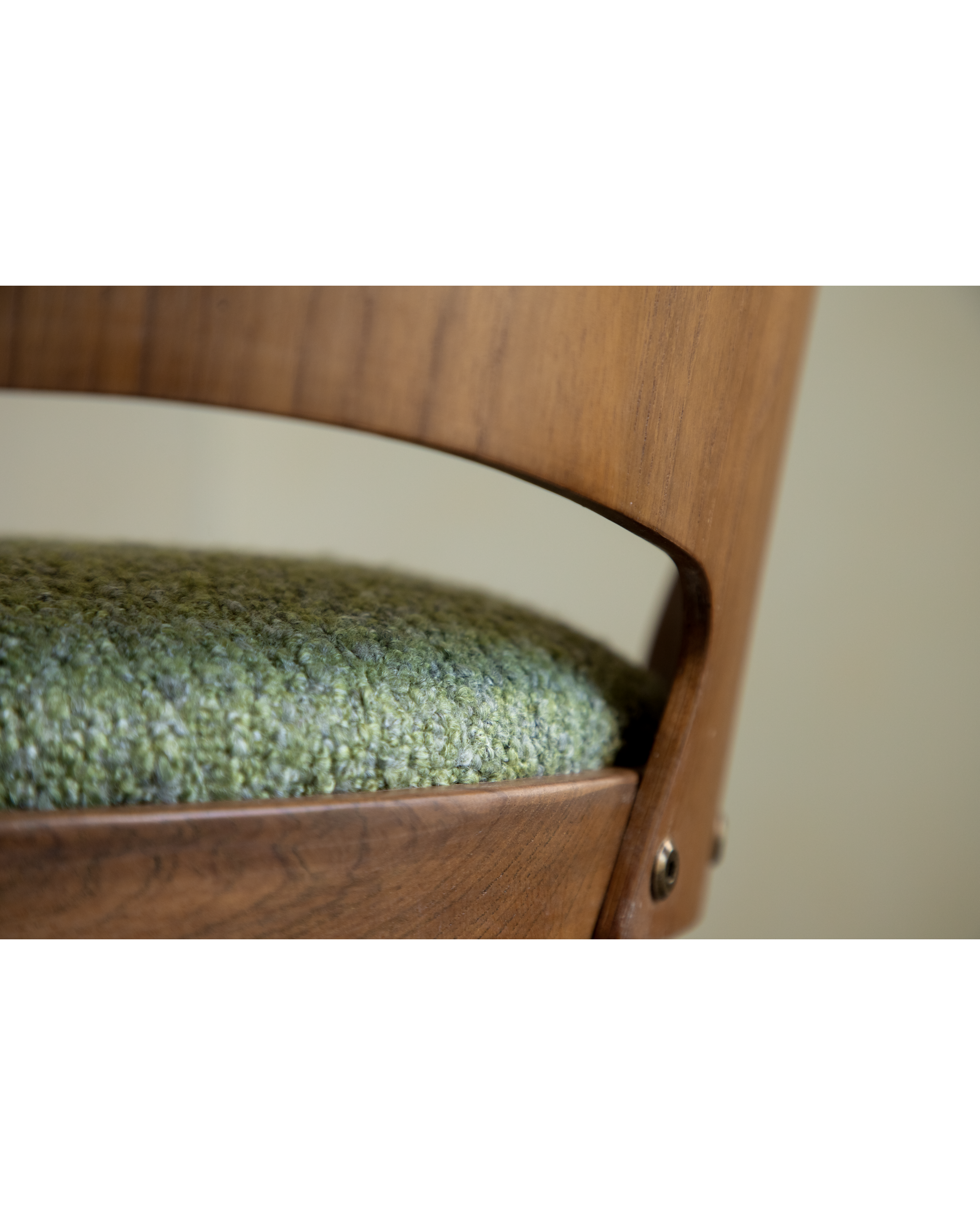 Shell Chair: Indigo textured seat cushion and teak wood frame detail.