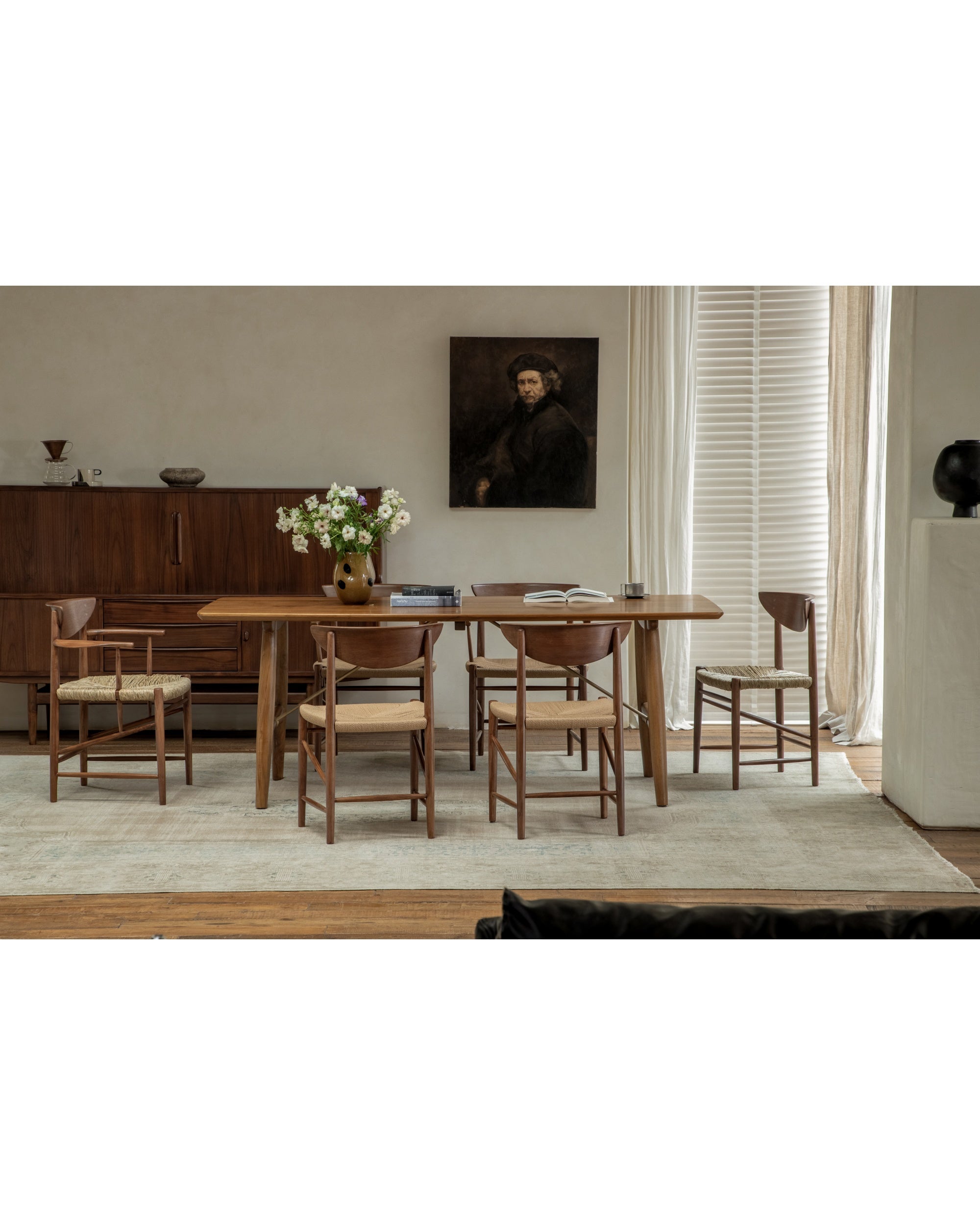 Henrik dining chair with teak frame and woven rush seat.