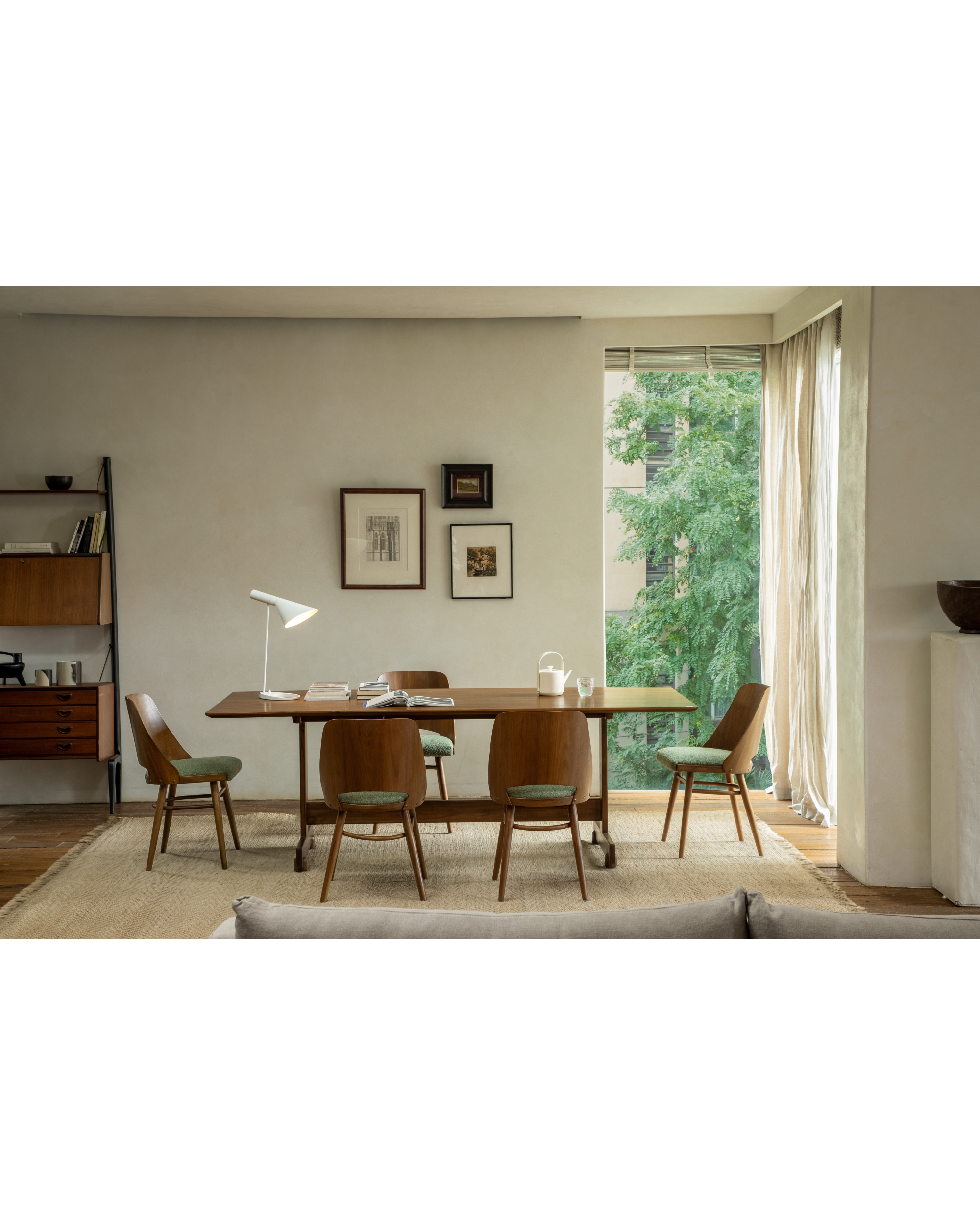 Teak Shell Chairs with green upholstered seats and curved backs, set around dining table.