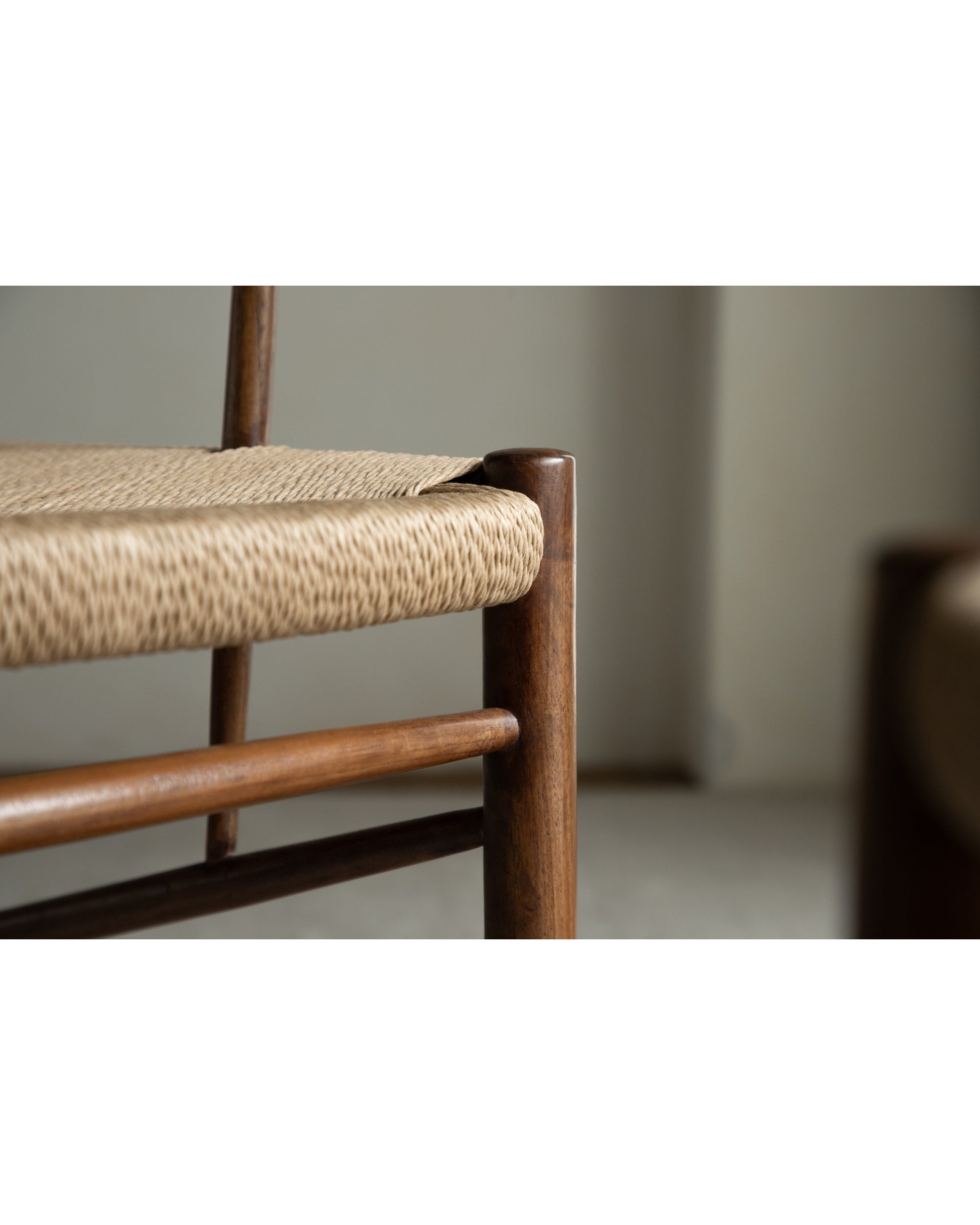 Detail of Henrik Dining Chair: handwoven rush seat and smooth teak frame.