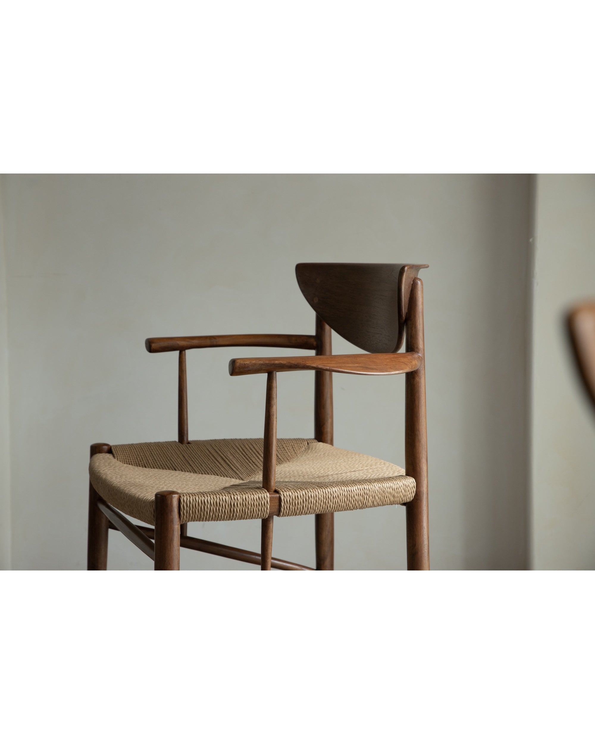Henrik Dining Chair, teak frame, woven rush seat, curved wood back detail.