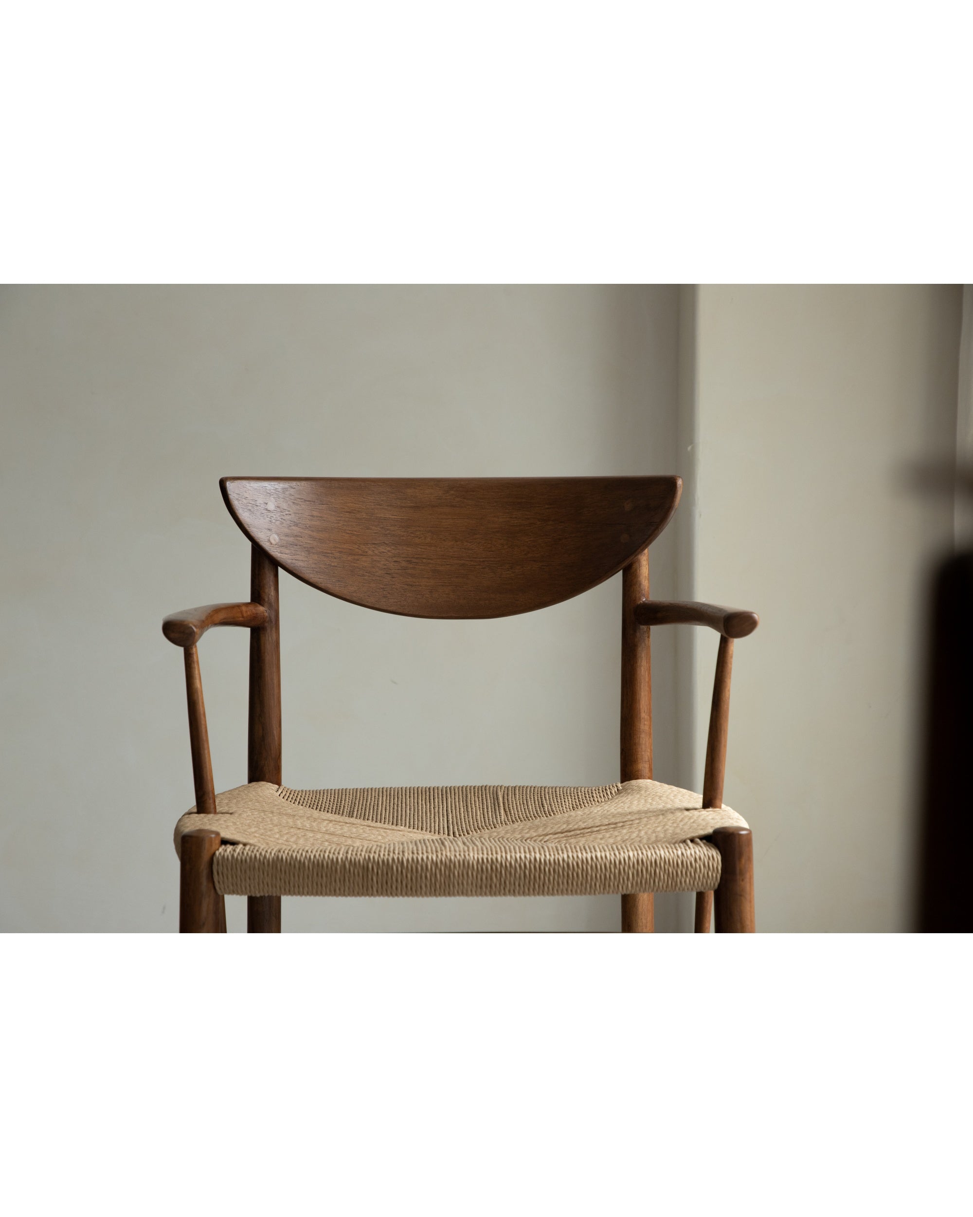 Henrik dining chair: solid teak frame, curved wood back, natural woven seat.