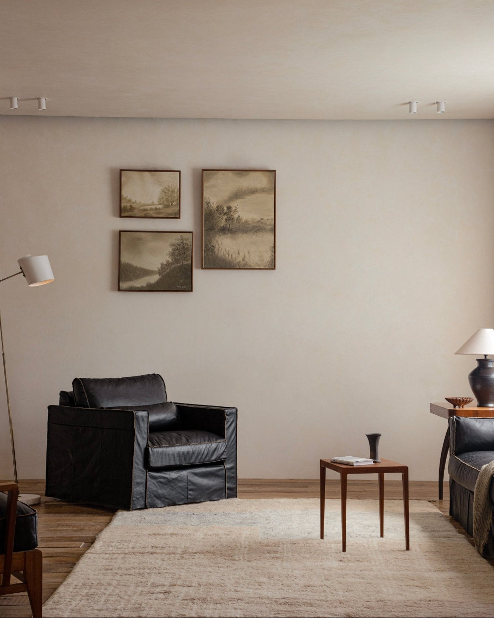 Black skirt leather armchair in a modern living room setting, emphasizing the elegant skirt design
