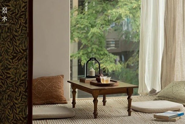 Reclaimed wood Tatami tea table with tea set and serene natural setting. THUMU brand
