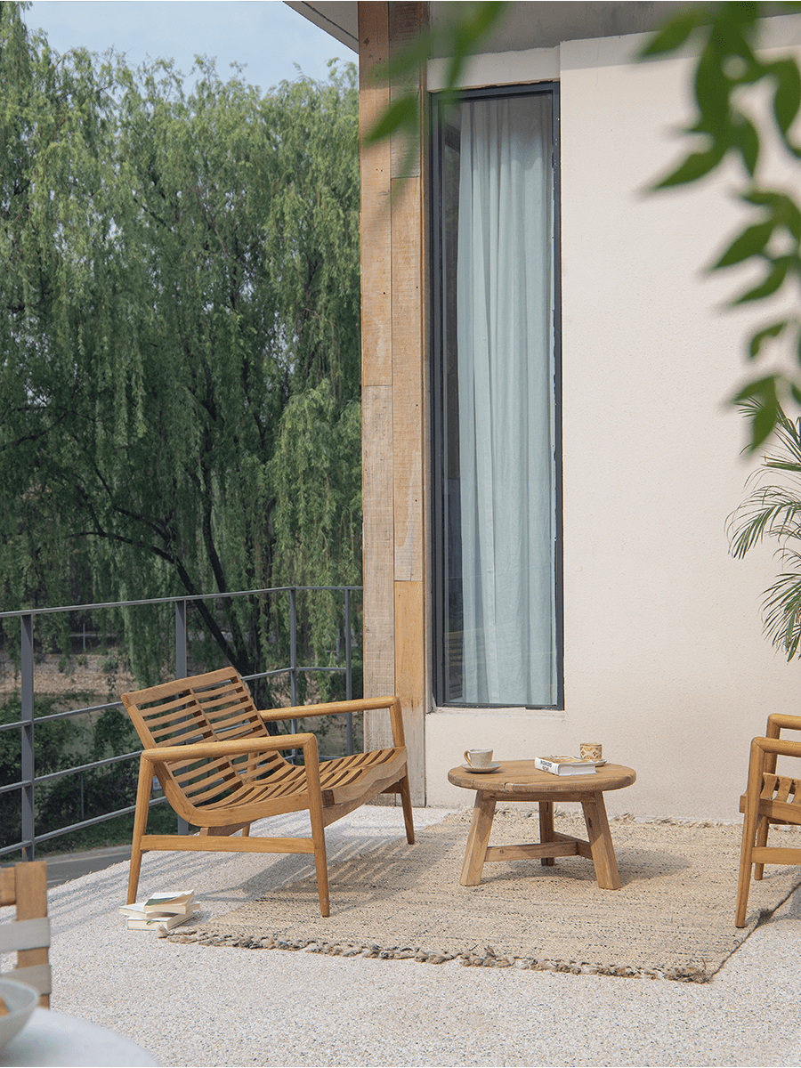 Teak wood garden lounge chair with slatted design, outdoor patio furniture, modern design, and wooden table