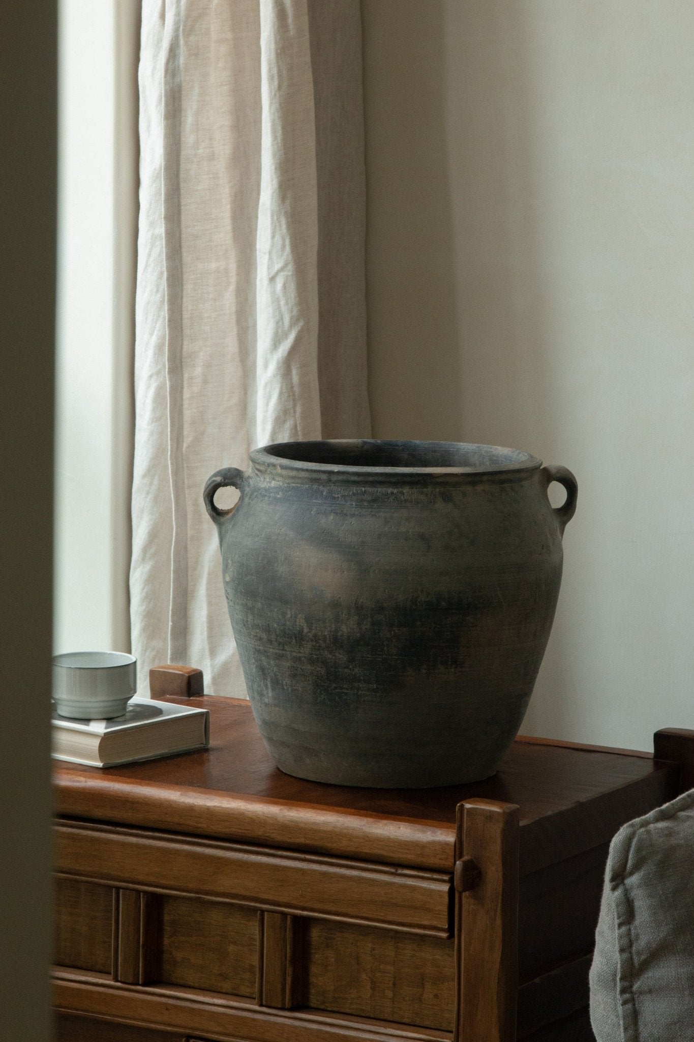 Large vintage clay pot with handles, home decor accent. Neutral colors and clay material.