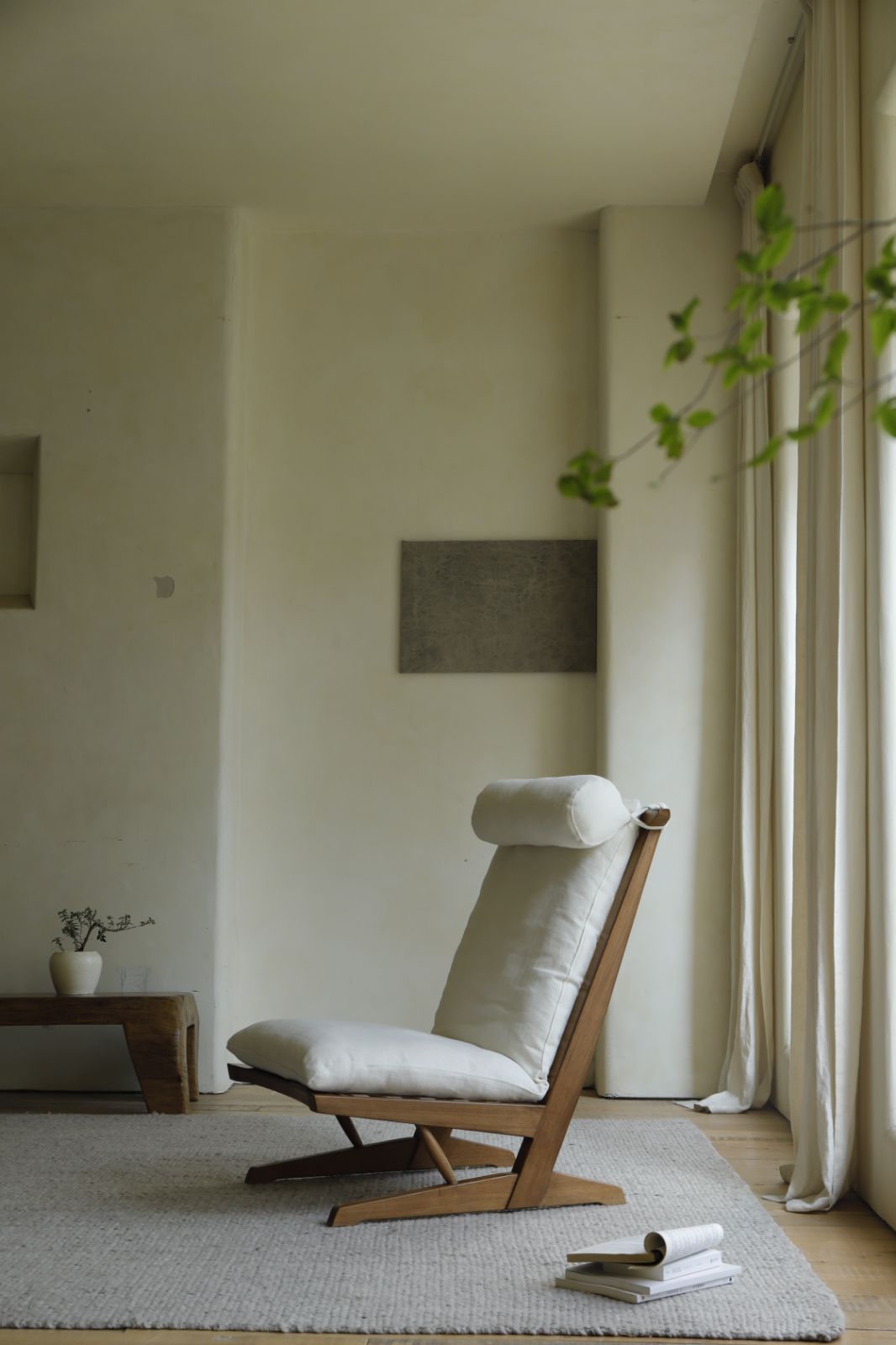 George Lounge Chair in teak wood with light cushion in modern interior