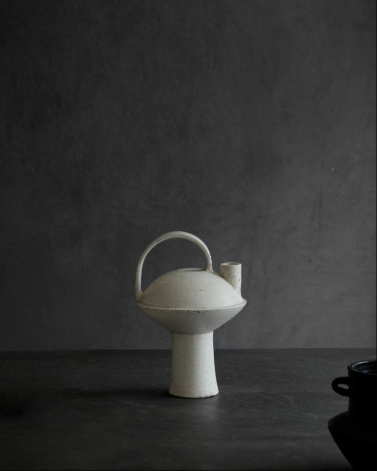 White ceramic vase with handle and spout, minimalist design, perfect for home decor