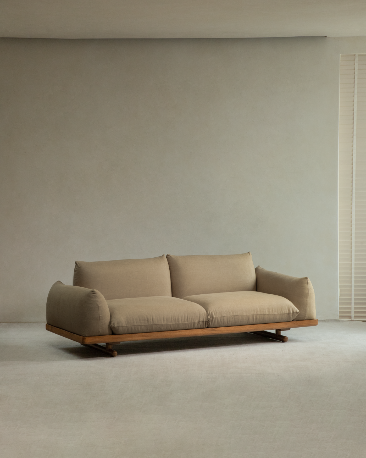 Adrian Sofa with beige linen cushions and solid teak wood base in minimalist living room