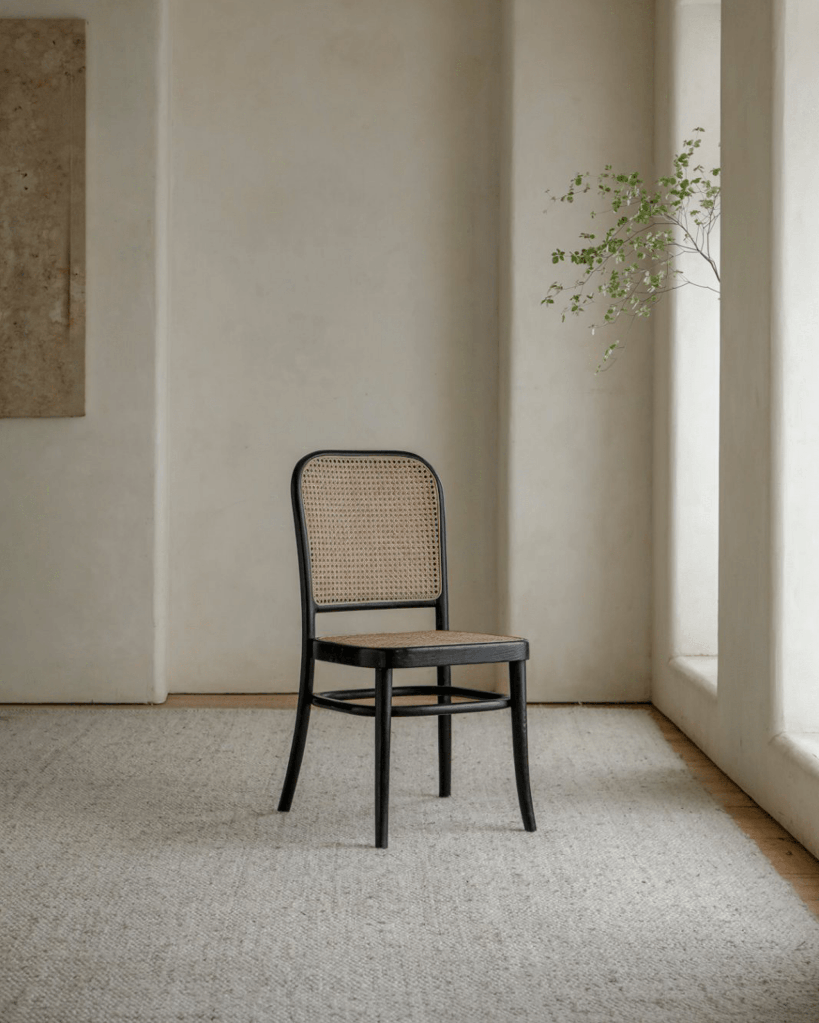 NO.811 Chair with black frame and rattan weaving in modern interior. Elegant home decor.