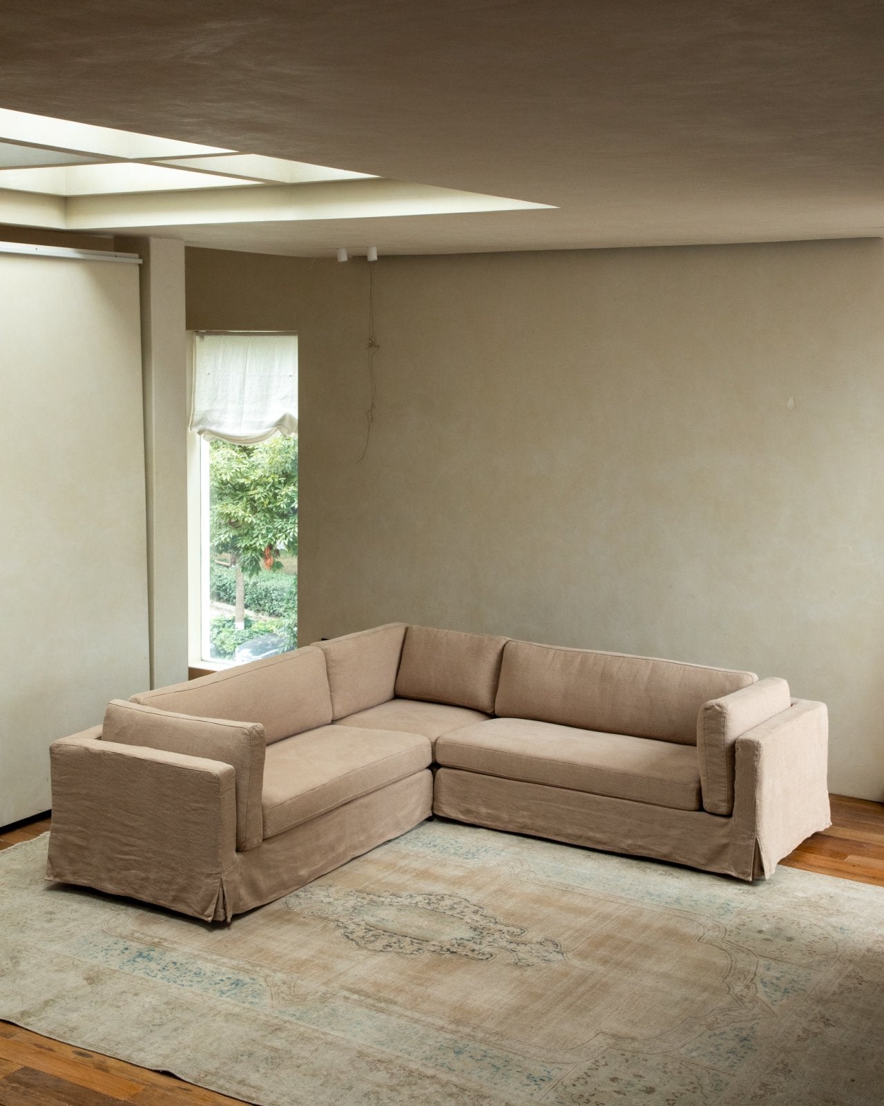 Beige linen skirt sectional sofa in modern living room, modular design, customizable comfort