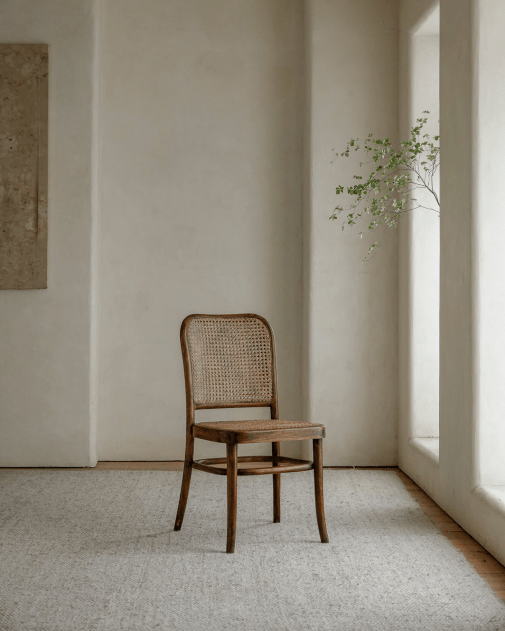 NO.811 Chair in a minimalist interior. Teak frame with rattan back and seat. Elegant design for home decor.