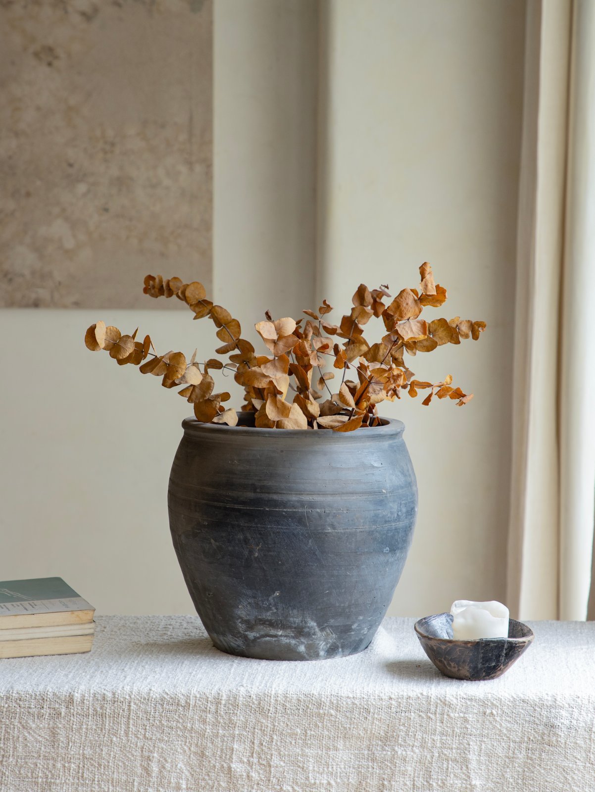 Vintage clay pot with dried eucalyptus, home decor accent, perfect for displaying clay pots.