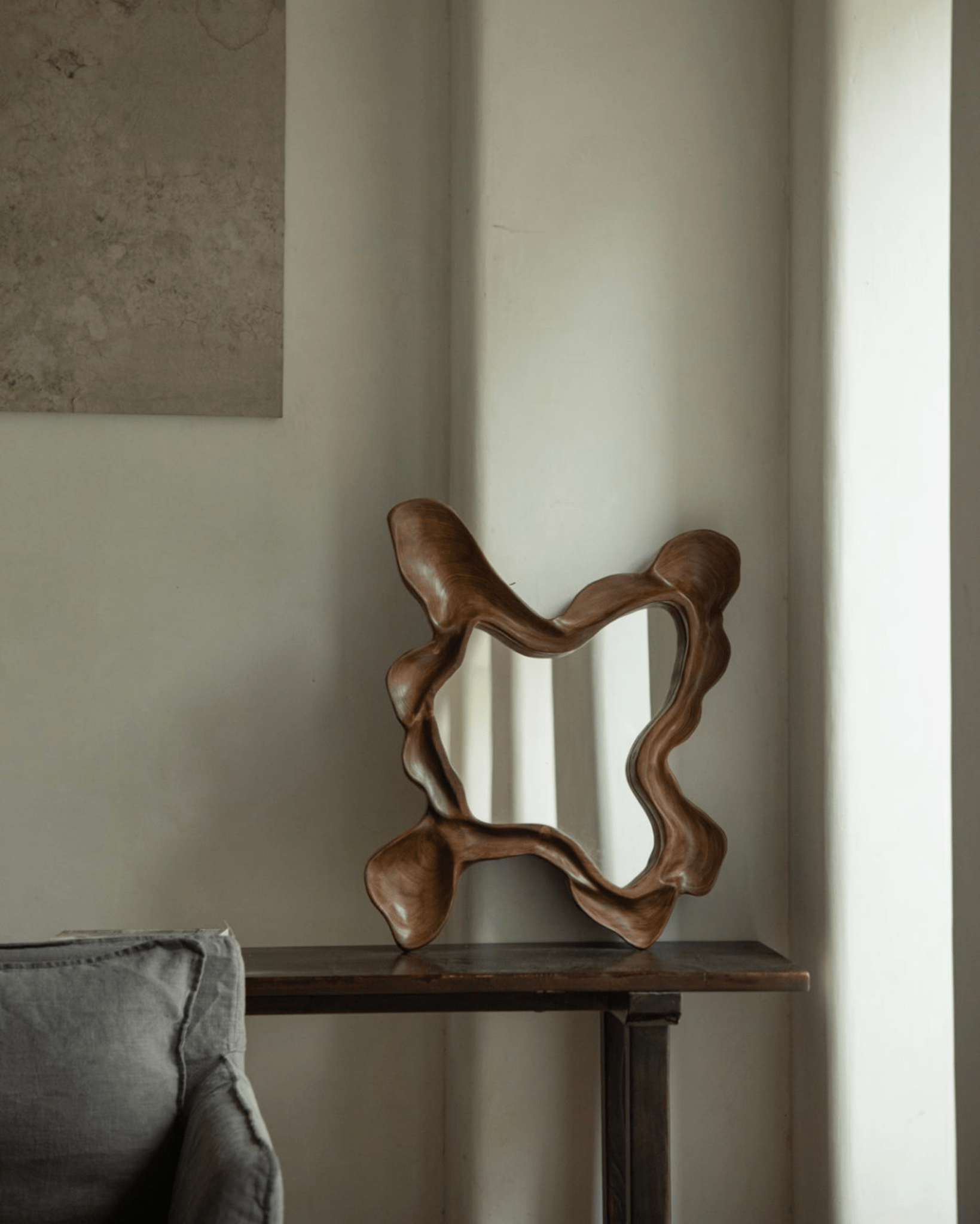 Organic Wood Arbor Mirror on dark table, modern wall decor, handcrafted shape