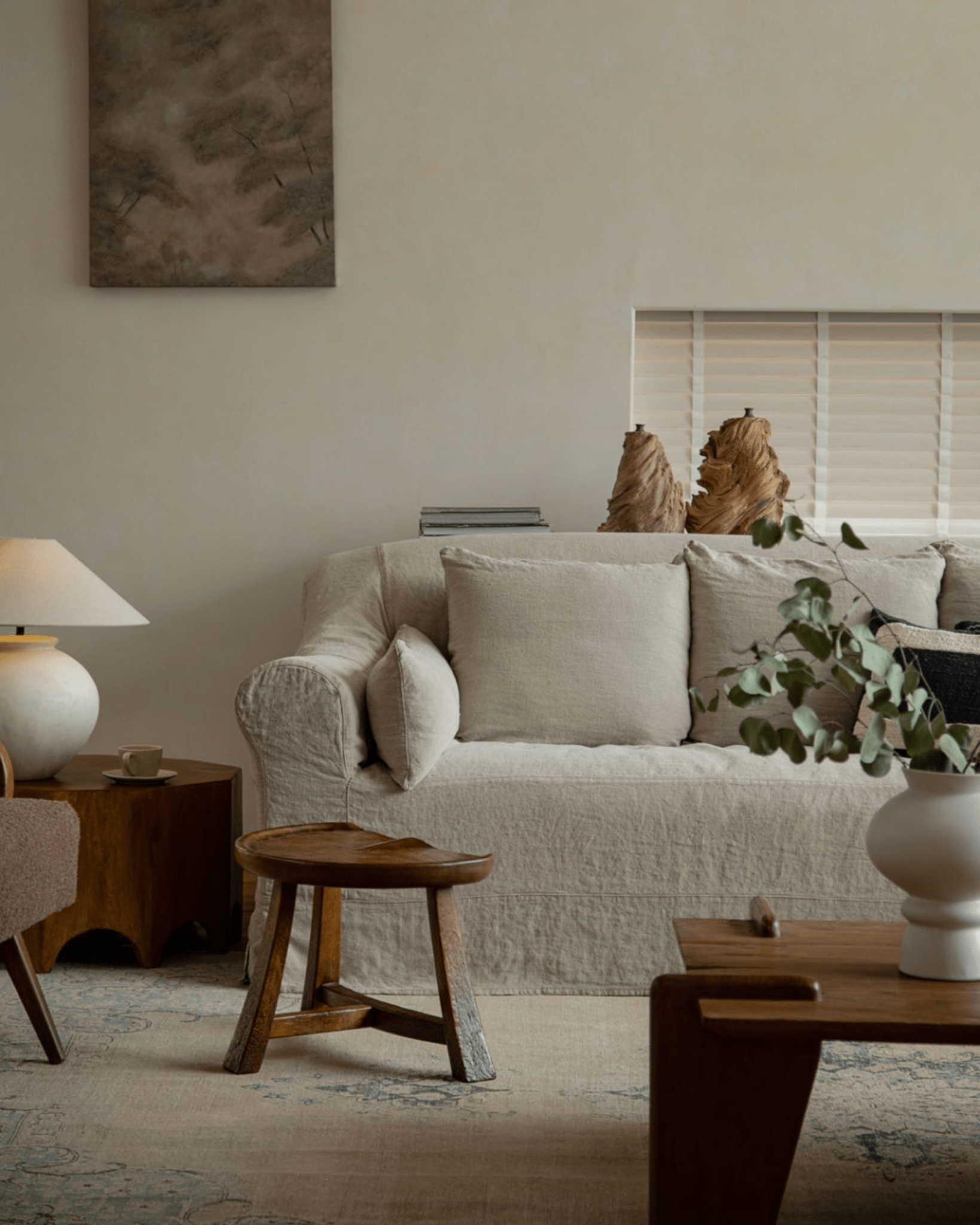 Pod Stool in a vintage living room setting with a natural wood finish, paired with sofa, table, and decor