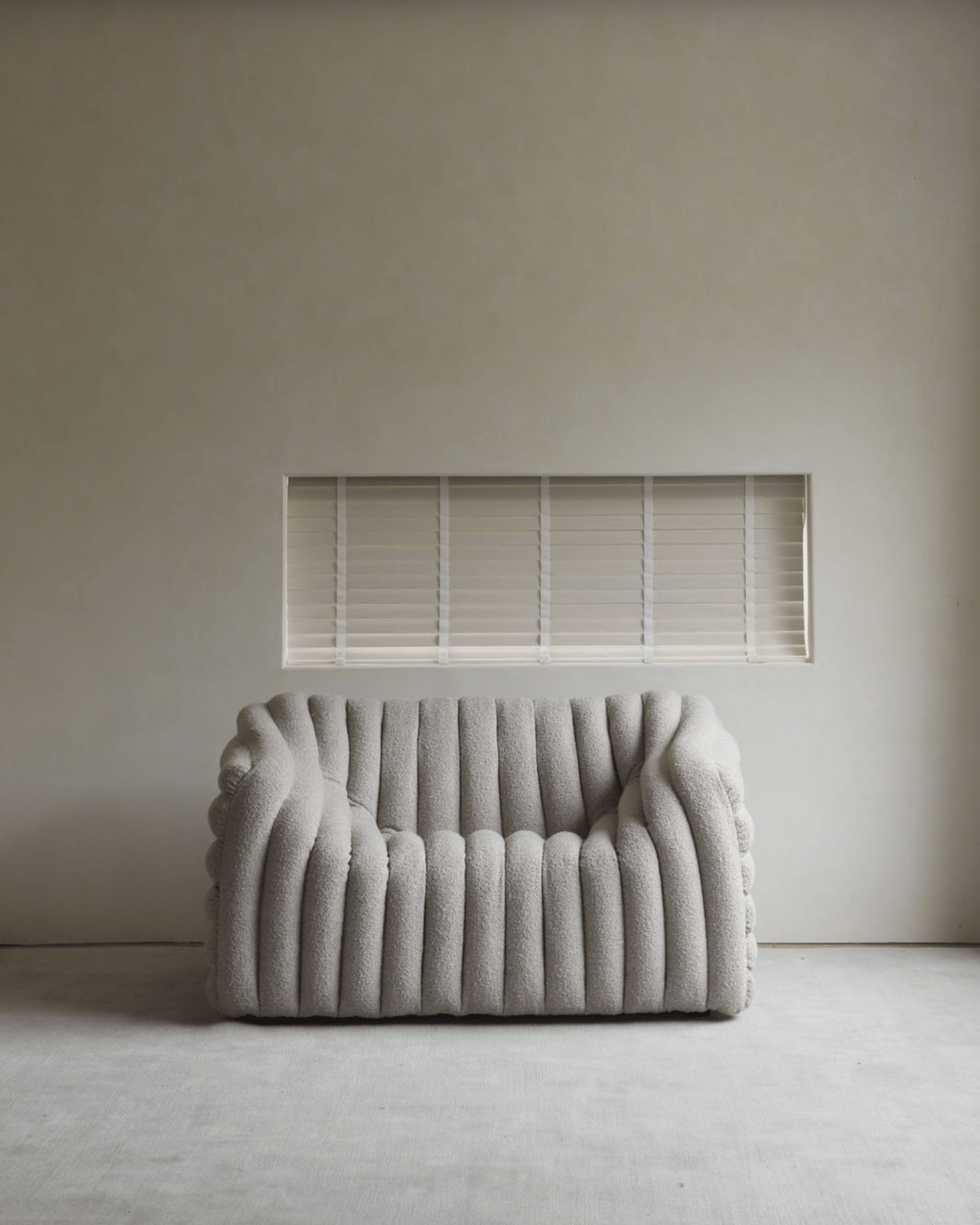 Miche Sofa in light grey, featuring a ribbed design and soft fabric, ideal for cozy living rooms.