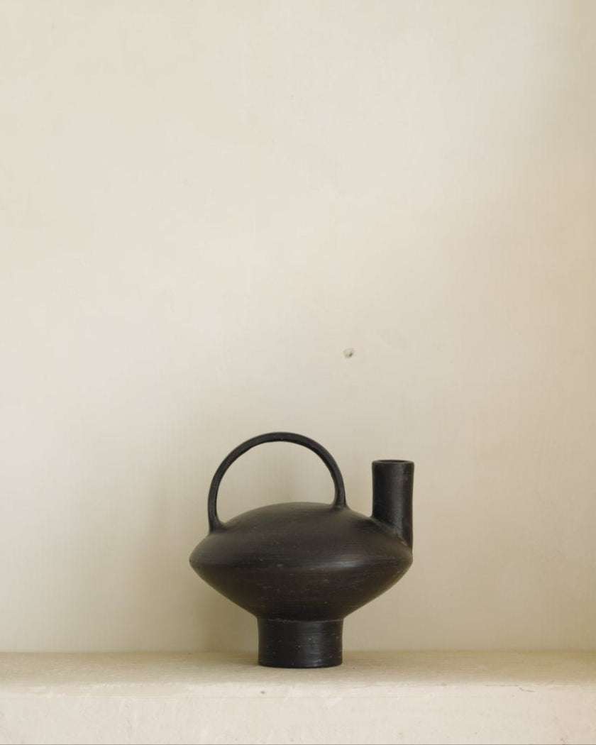 Black ceramic vase with handle and spout, minimalist design, perfect for modern home decor.
