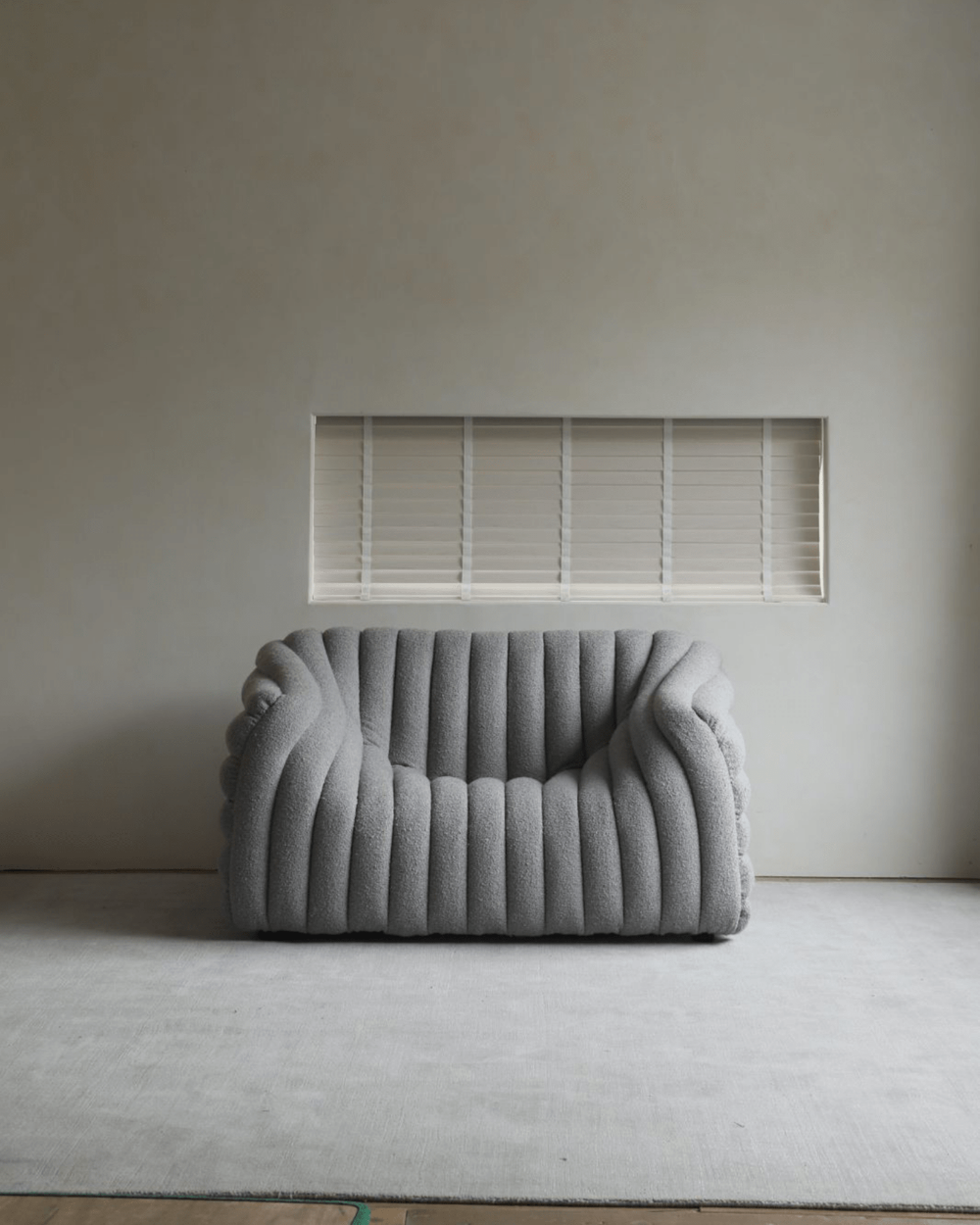 Miche Sofa in light grey, vertical ribbed design, cozy and comfortable in modern living room, perfect for relaxation.