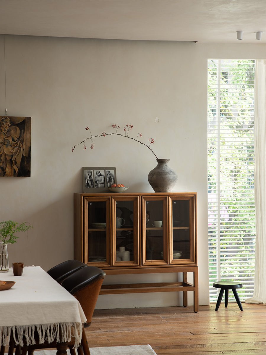 Teak wood Stilt Cabinet with glass doors in a dining room, elegant display and storage solution