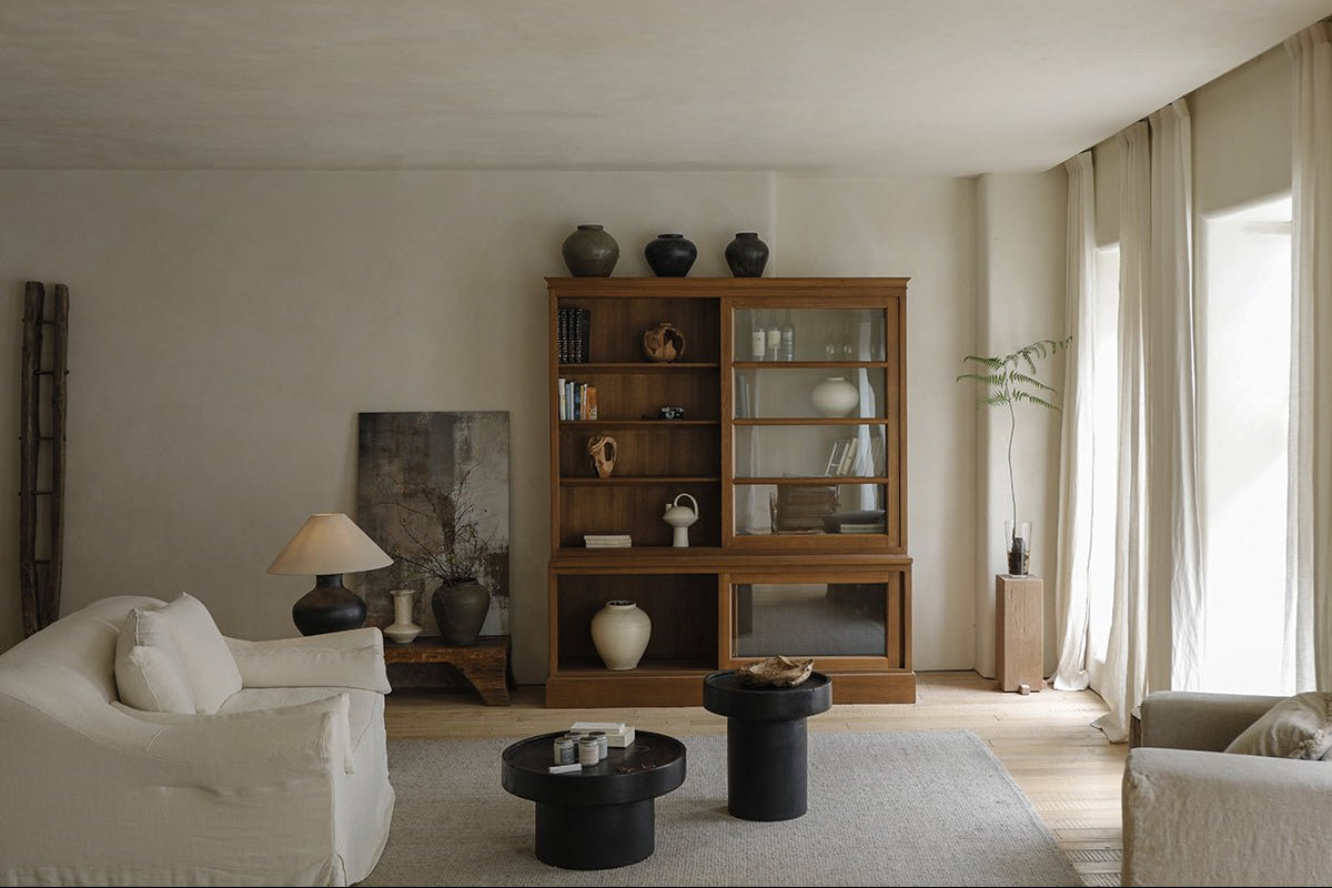 Elegant African teak glass bookcase in a living room setting with display of books and decor. Versatile storage solution.