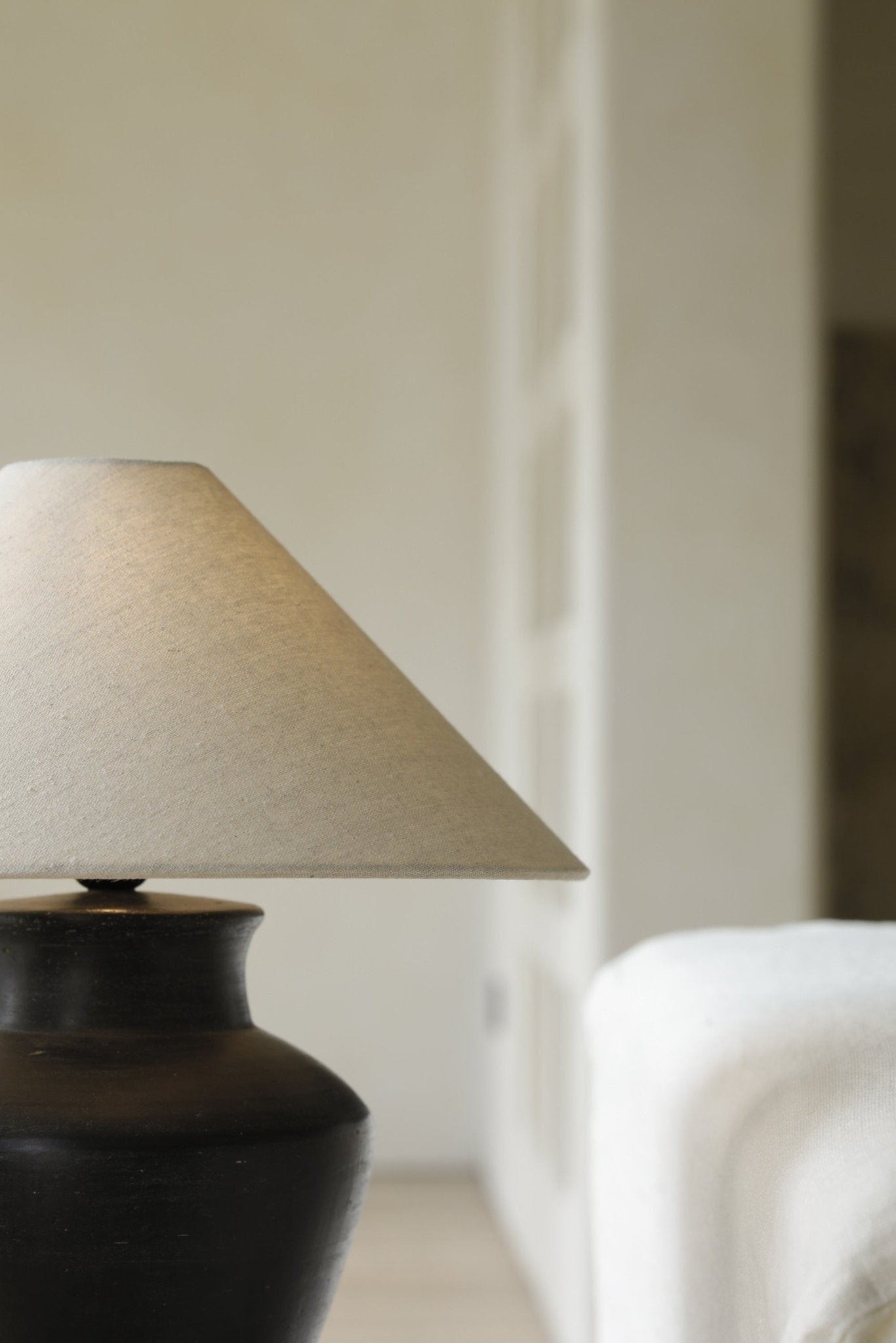 Short neck lamp with clay base and linen shade, interior design