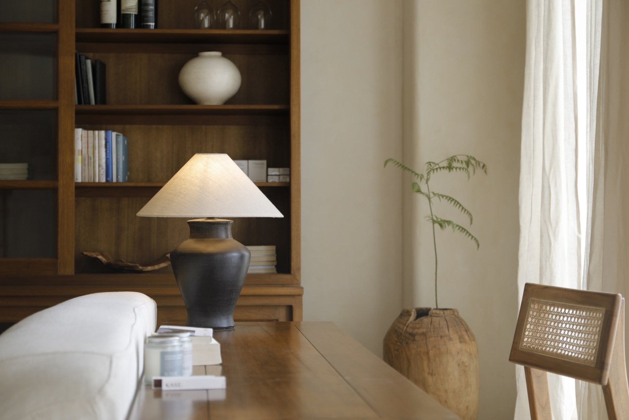 Short neck lamp with clay base and linen shade, interior design