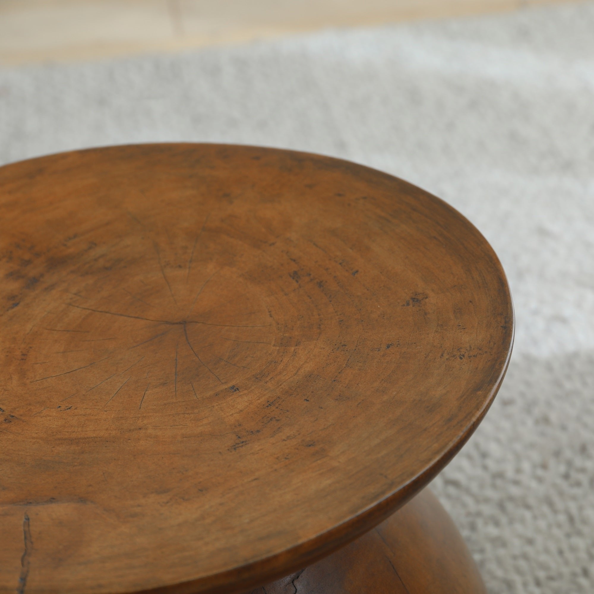 Sandglass Table detail made of Samanea saman wood, brown surface, natural wood grain.