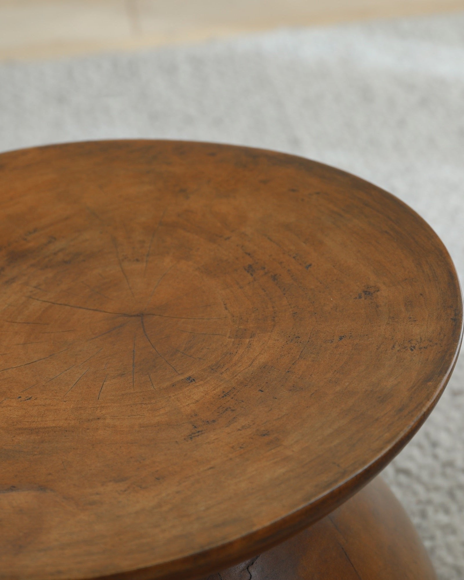Sandglass Table detail made of Samanea saman wood, brown surface, natural wood grain.