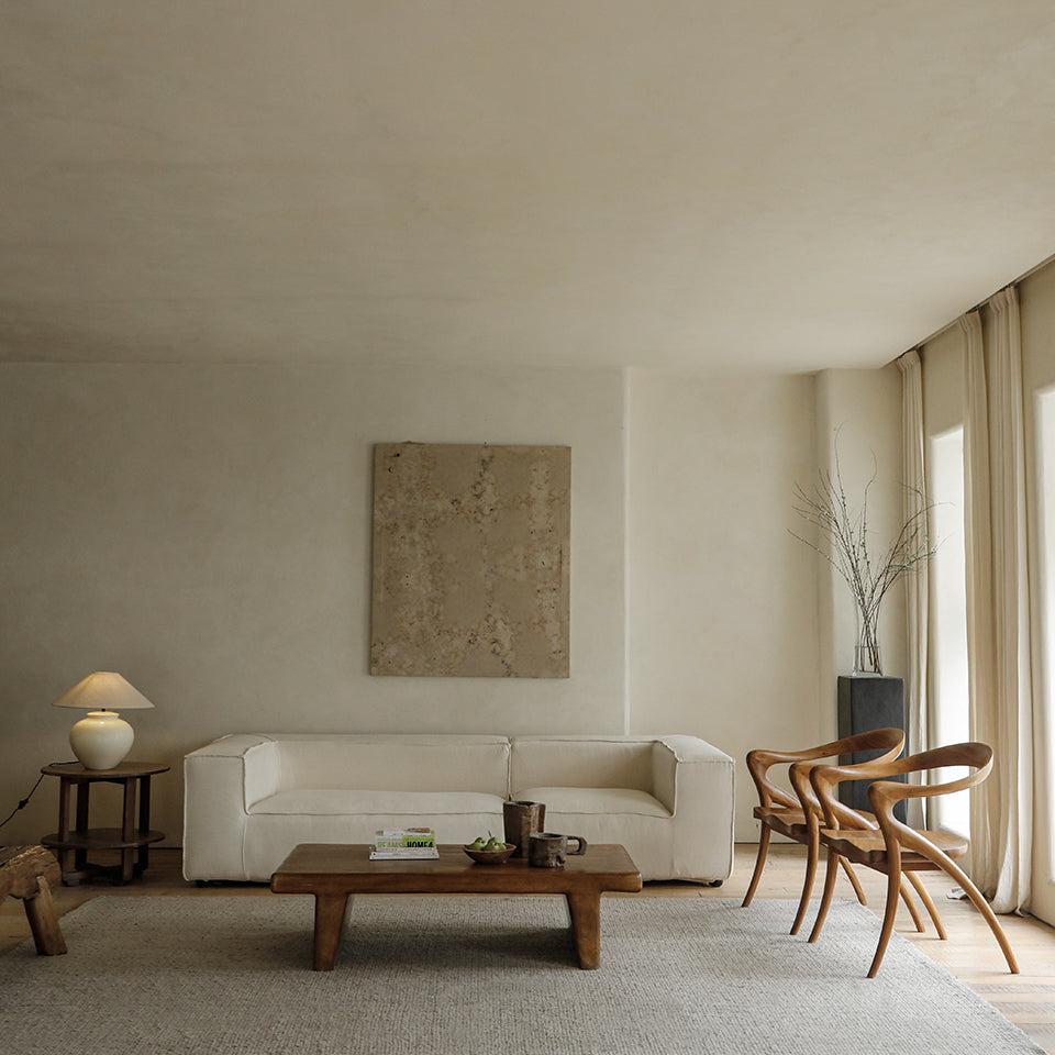 Olivia Chair in a modern interior. Solid teak wood chairs with curved back and seat design.