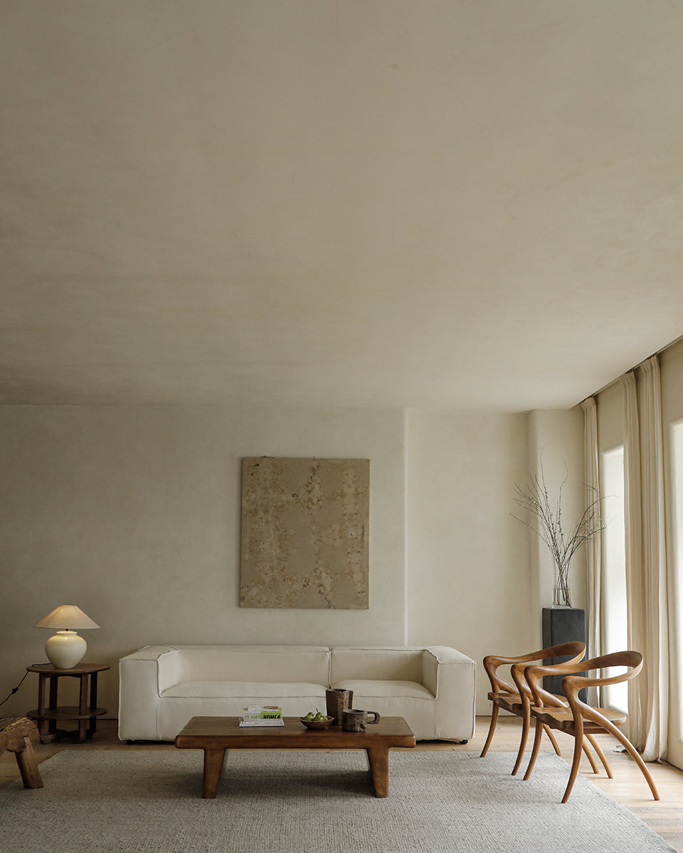 Olivia Chair in a modern interior. Solid teak wood chairs with curved back and seat design.